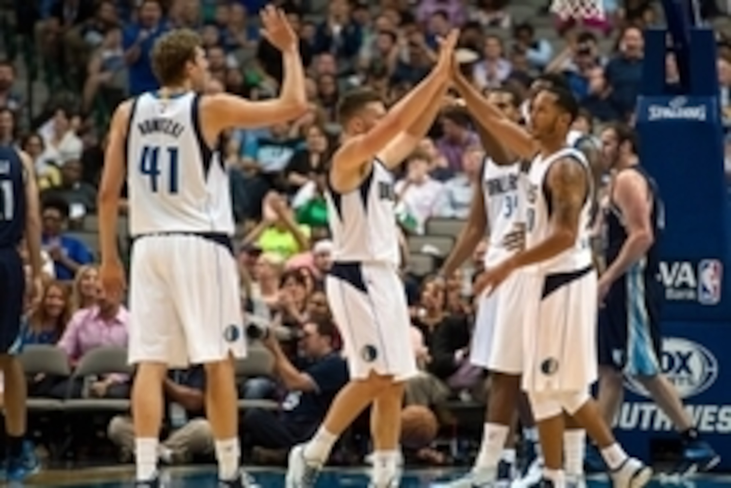 Oct 20, 2014; Dallas, TX, USA; Dallas Mavericks forward Dirk Nowitzki (41) and forward Chandler Parsons (25) and guard Devin Harris (20) congratulate forward Al-Farouq Aminu (7) during the first half against the Memphis Grizzlies at the American Airlines 