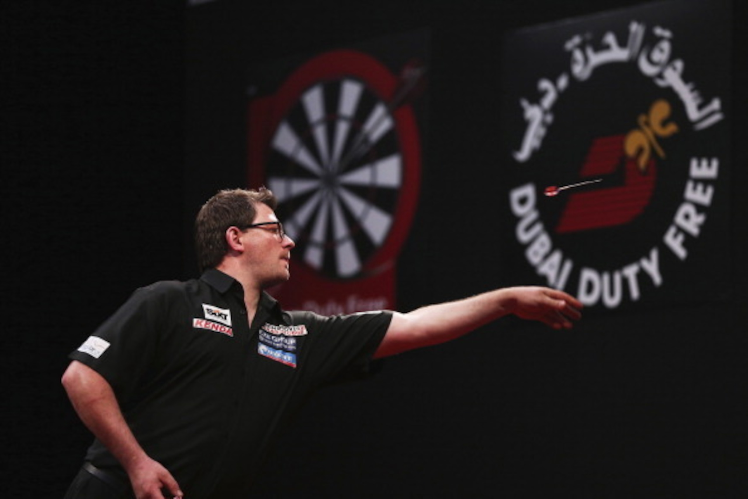 DUBAI, UNITED ARAB EMIRATES - MAY 29: James Wade of England plays against Michael Van Gerwen of the Netherland during the 2014 Dubai Duty Free Darts Masters Quarter-Final match at Dubai Duty Free Tennis Stadium, Irish Village on May 29, 2014 in Dubai, Un DUBAI, UNITED ARAB EMIRATES - MAY 29: James Wade of England plays against Michael Van Gerwen of the Netherland during the 2014 Dubai Duty Free Darts Masters Quarter-Final match at Dubai Duty Free Tennis Stadium, Irish Village on May 29, 2014 in Dubai, Un
