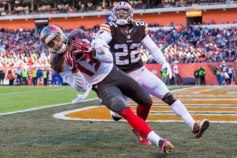 CLEVELAND, OH - NOVEMBER 2: Wide receiver Mike Evans #13 of the Tampa Bay Buccaneers catches a touchdown pass while under pressure from cornerback Buster Skrine #22 of the Cleveland Browns during the second half at FirstEnergy Stadium on November 2, 2014 
