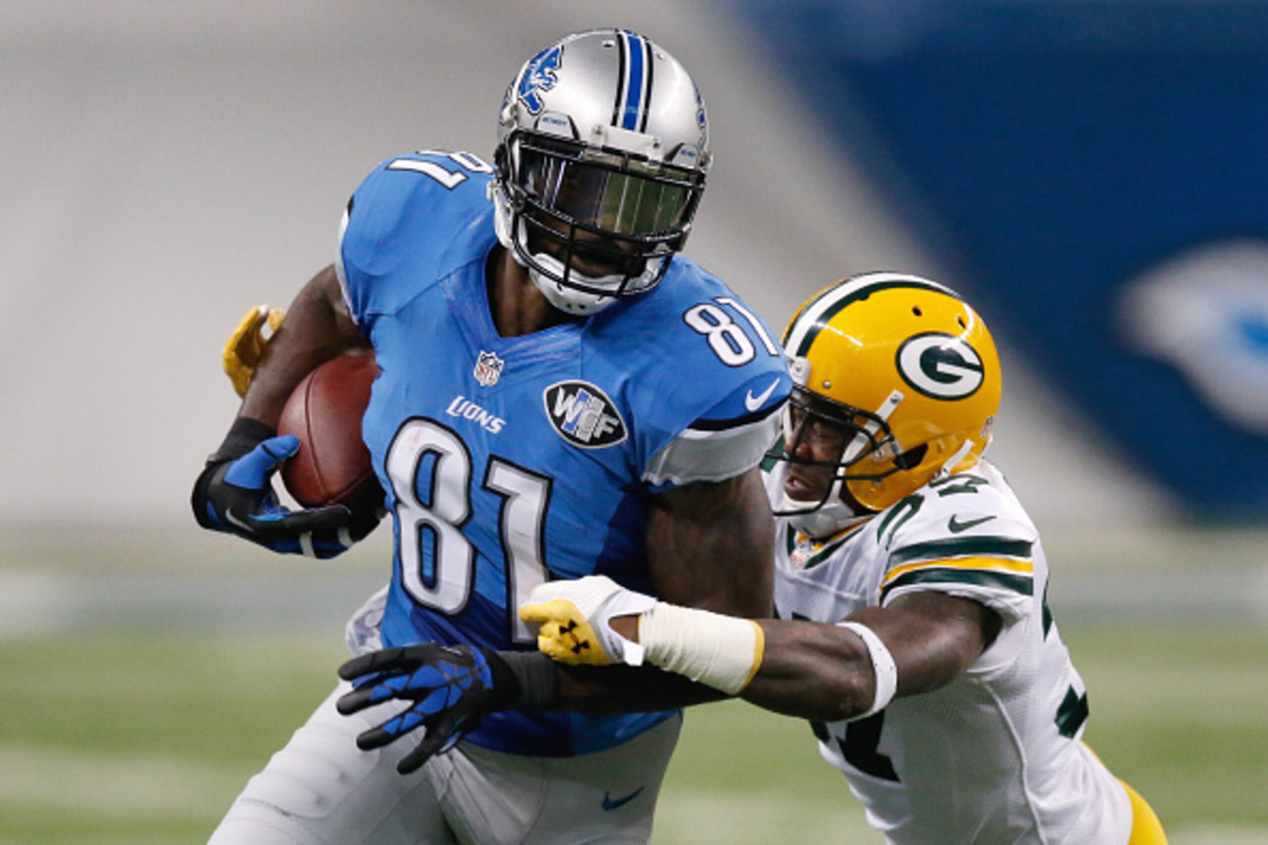 DETROIT, MI - SEPTEMBER 21: Calvin Johnson #81 of the Detroit Lions looks to avoid the tackle by Sam Shields #37 of the Green Bay Packers in the third quarter at Ford Field on September 21, 2014 in Detroit, Michigan. (Photo by Gregory Shamus/Getty Images)