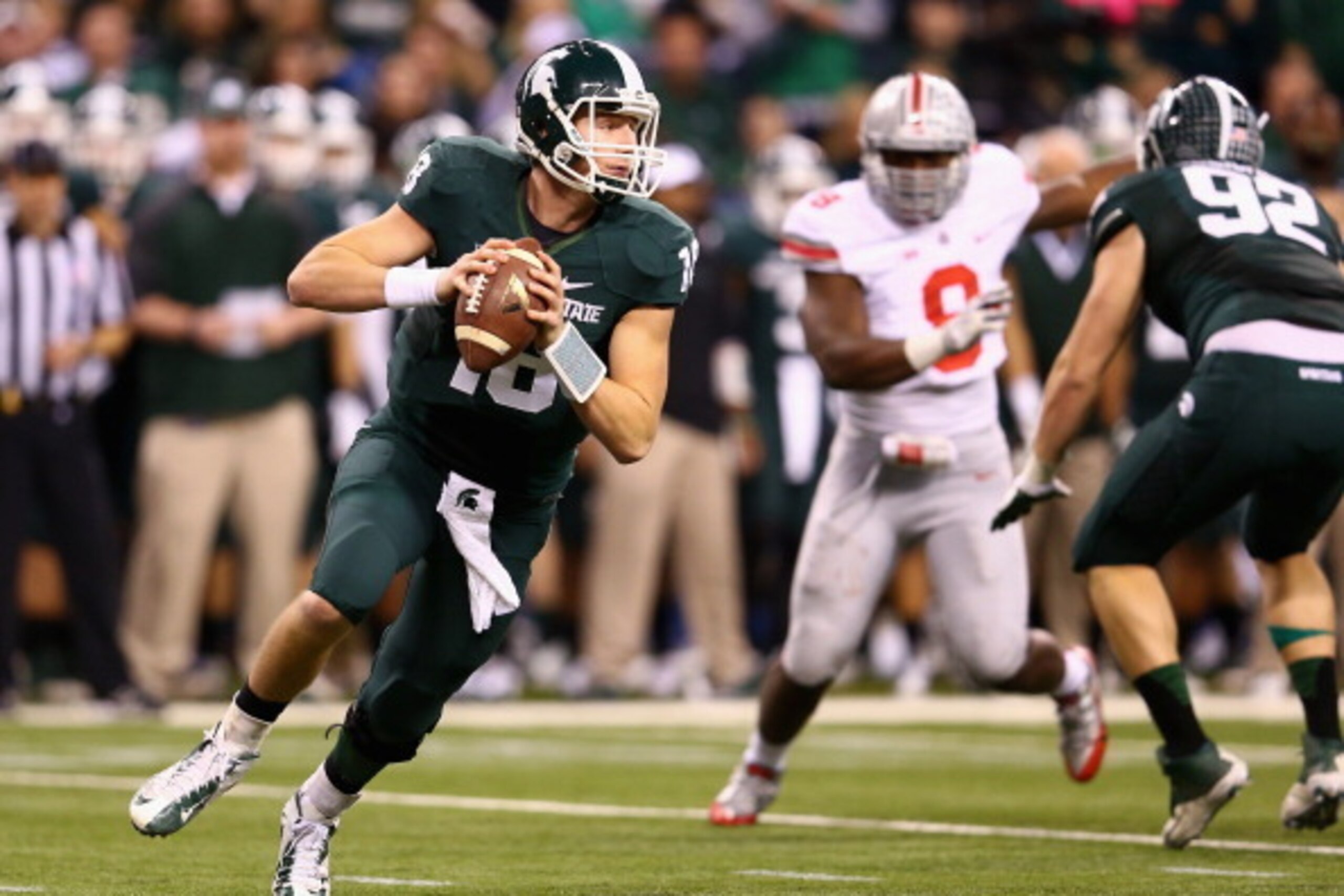 INDIANAPOLIS, IN - DECEMBER 07:  Quarterback Connor Cook #18 of the Michigan State Spartans looks to pass against the defense of the Ohio State Buckeyes during the Big Ten Conference Championship game at Lucas Oil Stadium on December 7, 2013 in Indianapol