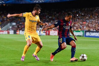 BARCELONA, SPAIN - SEPTEMBER 17:  Adriano Correia of FC Barcelona competes for the ball with Constantinos Charalambides of APOEL FC during the UEFA Champions League Group F match between FC Barcelona and APOEL FC at the Camp Nou Stadium on September 17, 2