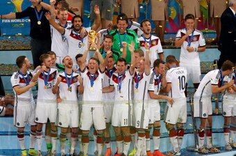 RIO DE JANEIRO, BRAZIL - JULY 13: Bastian Schweinsteiger of Germany raises the World Cup trophy in celebration with his teammates after defeating Argentina 1-0 in extra time during the 2014 FIFA World Cup Brazil Final match between Germany and Argentina a