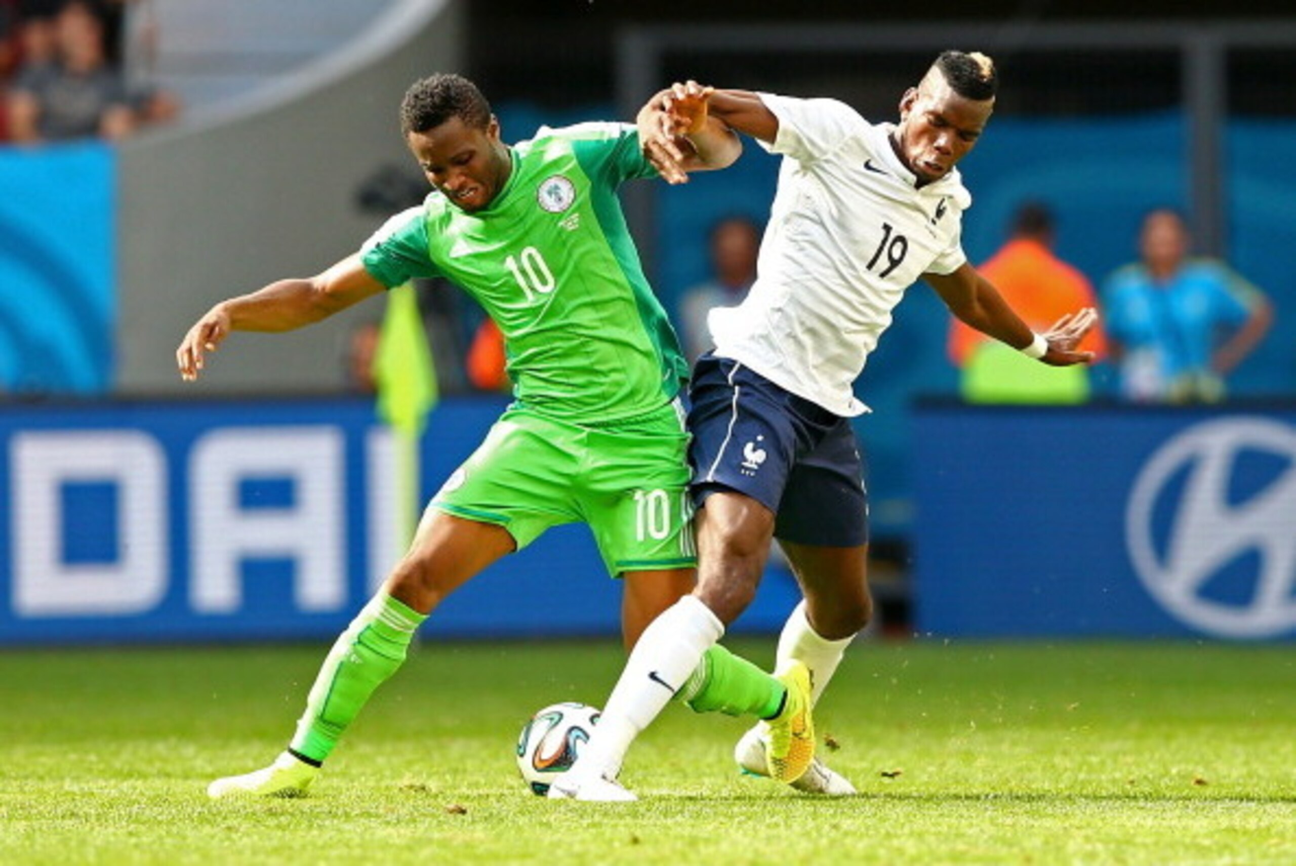 BRASILIA, BRAZIL - JUNE 30: John Obi Mikel of Nigeria challenges Paul Pogba of France during the 2014 FIFA World Cup Brazil Round of 16 match between France and Nigeria at Estadio Nacional on June 30, 2014 in Brasilia, Brazil.  (Photo by Quinn Rooney/Gett