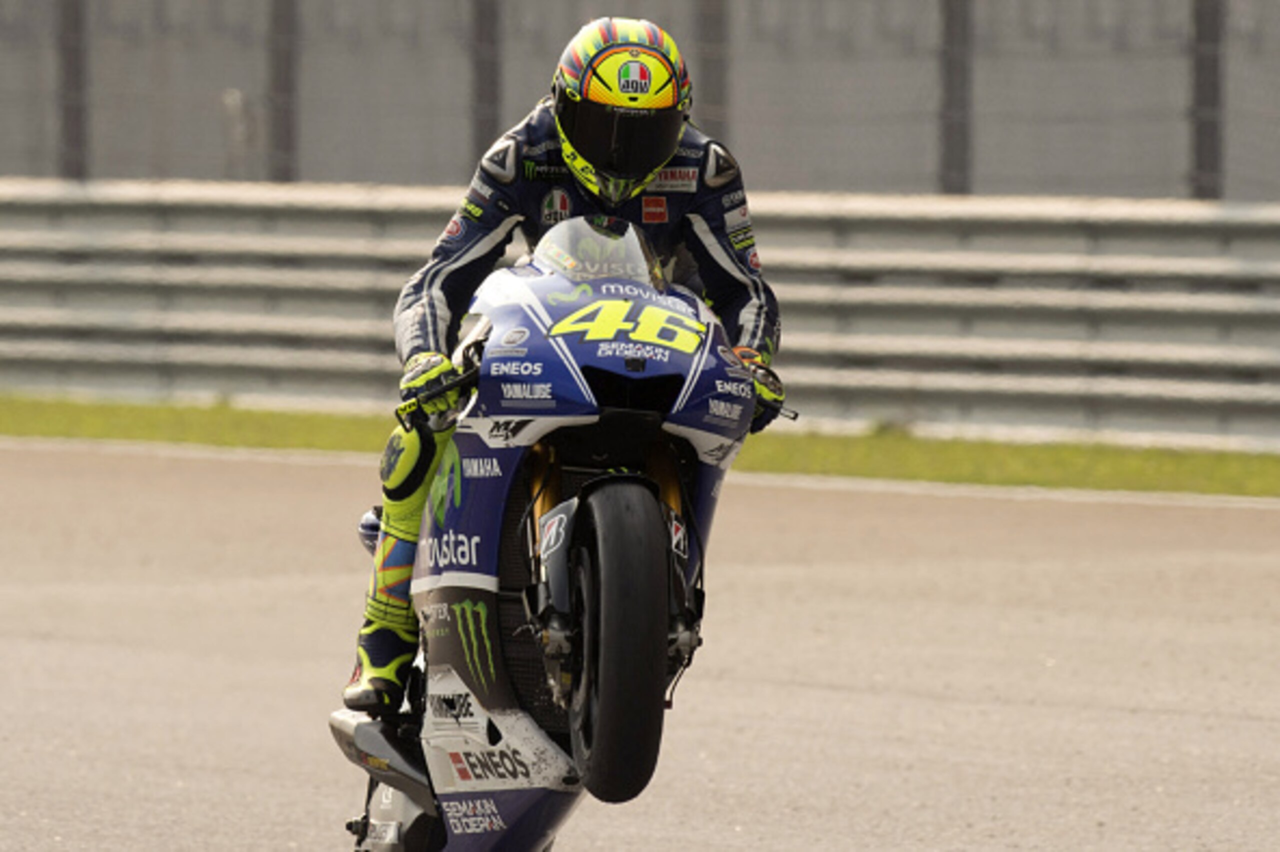 KUALA LUMPUR, MALAYSIA - OCTOBER 26:  Valentino Rossi of Italy and Movistar Yamaha MotoGP lifts the front wheel in celebration at the end of  the MotoGP race during the MotoGP Of Malaysia - Race at Sepang Circuit on October 26, 2014 in Kuala Lumpur, Malay