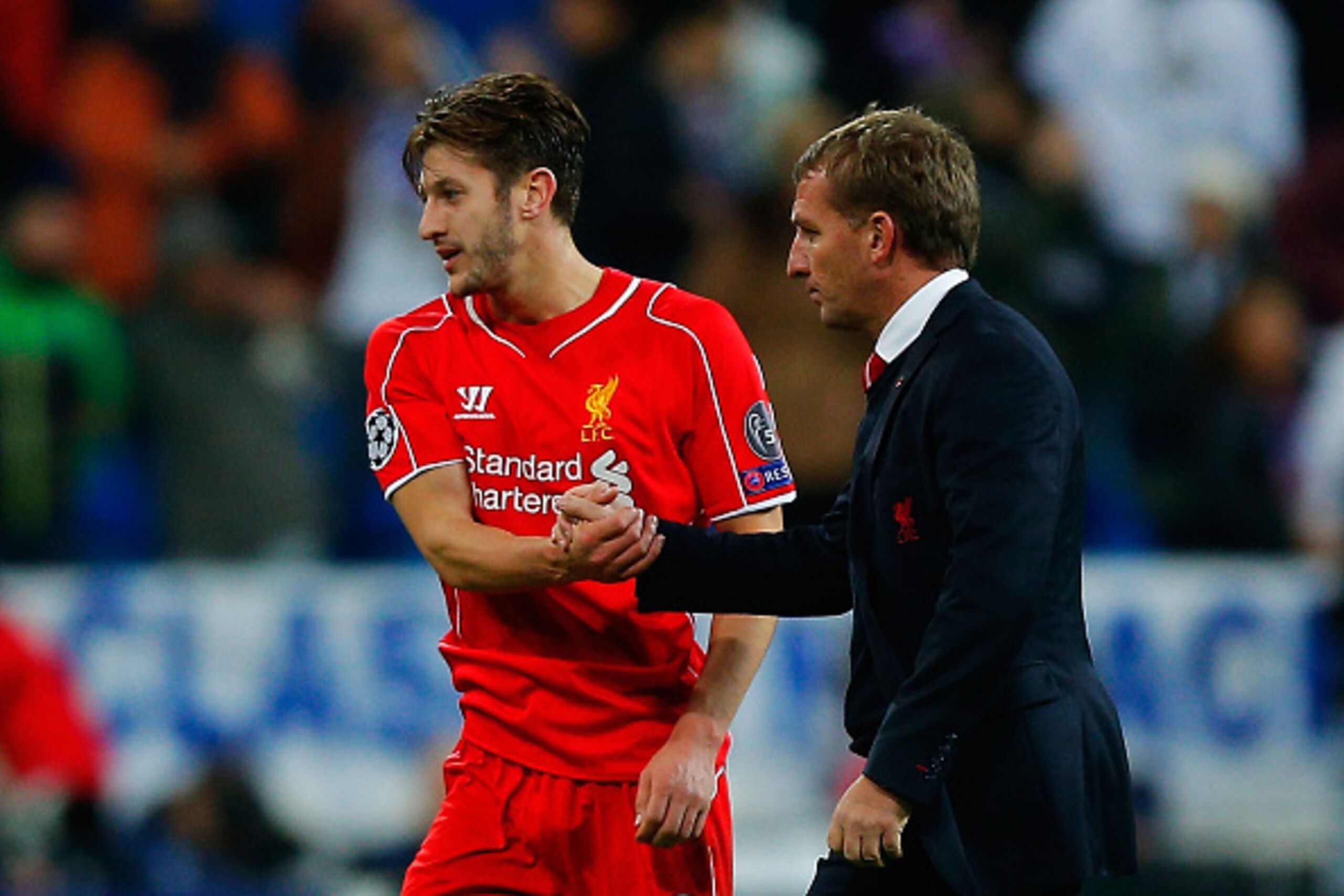 MADRID, SPAIN - NOVEMBER 04: Adam Lallana (L) of Liverpool FC shakes hands with his head coach Brendan Rodgers (R) after the UEFA Champions League Group B match between Real Madrid CF and Liverpool FC at Estadio Santiago Bernabeu on November 4, 2014 in Ma