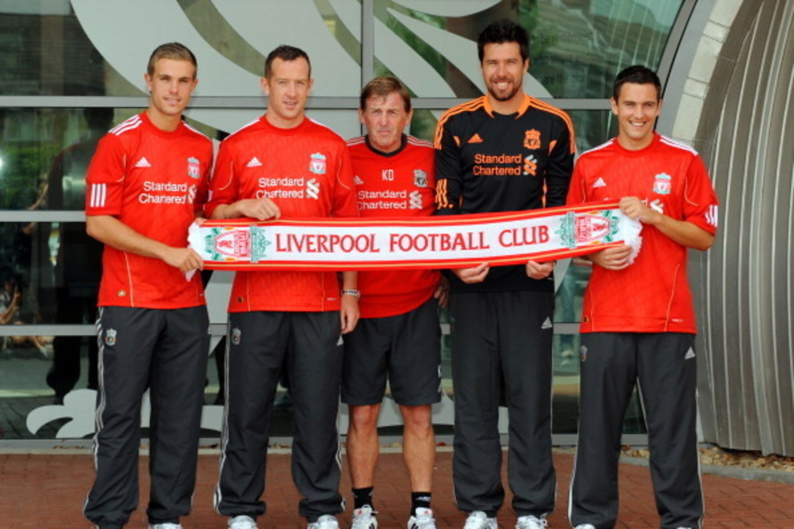 LIVERPOOL, UNITED KINGDOM - AUGUST 03:  Manager Kenny Dalglish (C) presents new signings (L-R) Jordan Henderson, Charlie Adam, Alexander Doni and Stewart Downing of Liverpool following a press conference at Melwood Training Ground on August 3, 2011 in Liv