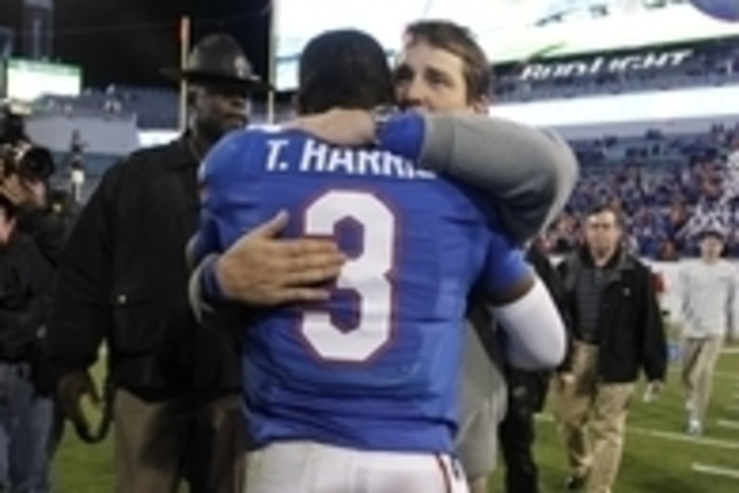 Nov 1, 2014; Jacksonville, FL, USA; Florida Gators head coach Will Muschamp hugs quarterback Treon Harris (3) after they beat the Georgia Bulldogs at EverBank Field. Florida Gators defeated the Georgia Bulldogs 38-20. Mandatory Credit: Kim Klement-USA TOD