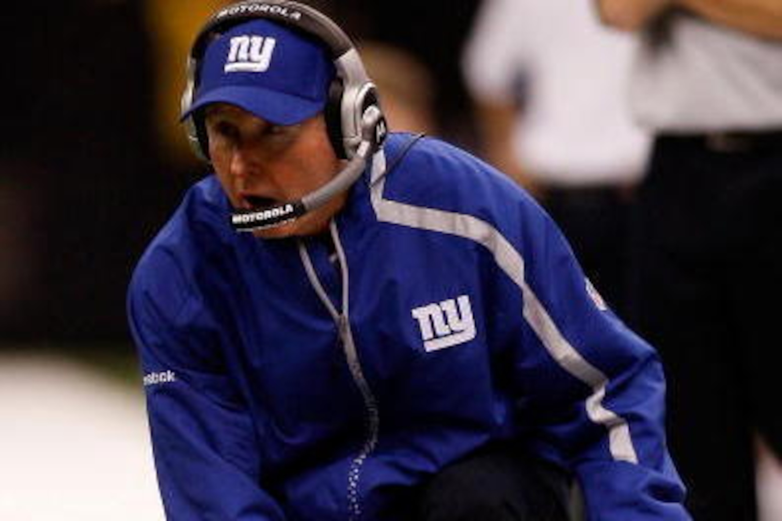 NEW ORLEANS - OCTOBER 18:  Head coach Tom Coughlin of the New York Giants pulls out the red challenge flag from his sock during the game against the New Orleans Saints at the Louisiana Superdome on October 18, 2009 in New Orleans, Louisiana.  (Photo by Ch