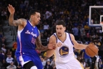 November 5, 2014; Oakland, CA, USA; Golden State Warriors guard Klay Thompson (11) dribbles the basketball against Los Angeles Clippers forward Matt Barnes (22) during the third quarter at Oracle Arena. The Warriors defeated the Clippers 121-104. Mandator