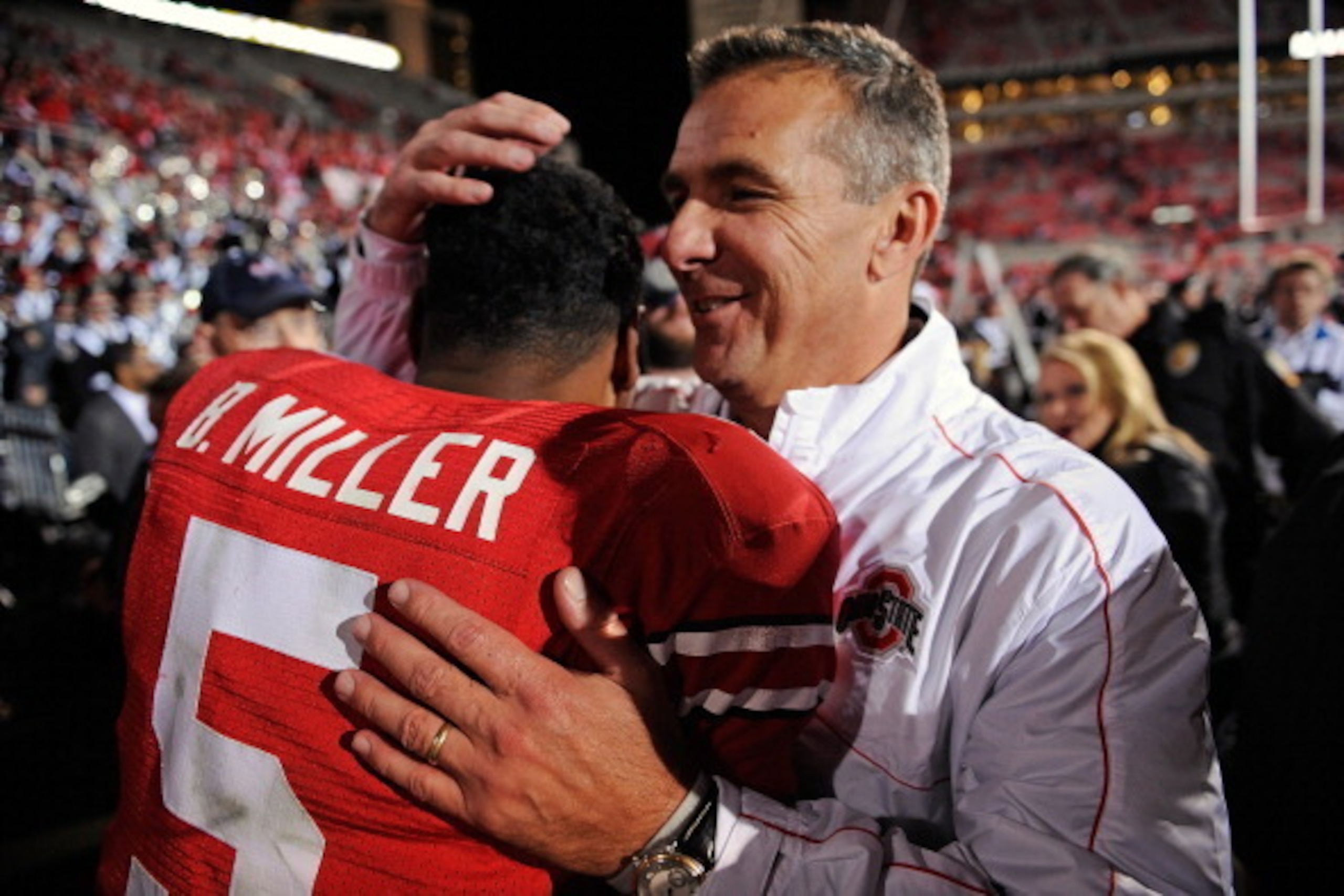 COLUMBUS, OH - OCTOBER 6:  Head Coach Urban Meyer hugs quarterback Braxton Miller #5 of the Ohio State Buckeyes after the Buckeyes defeated the Nebraska Cornhuskers 63-38 at Ohio Stadium on October 6, 2012 in Columbus, Ohio.  (Photo by Jamie Sabau/Getty I
