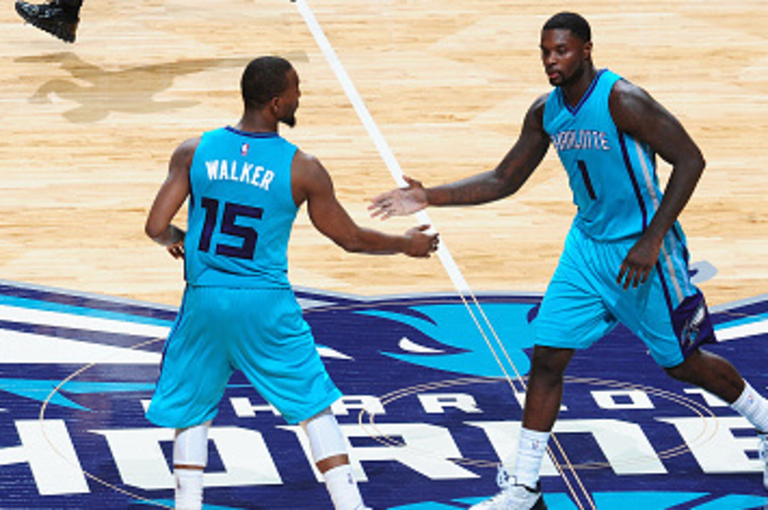 CHARLOTTE, NC - OCTOBER 29: Kemba Walker #15 and Lance Stephenson #1 of the Charlotte Hornets celebrate after a score against the Milwaukee Bucks on October 29, 2014 at Time Warner Cable Arena in Charlotte, North Carolina.  NOTE TO USER: User expressly ac