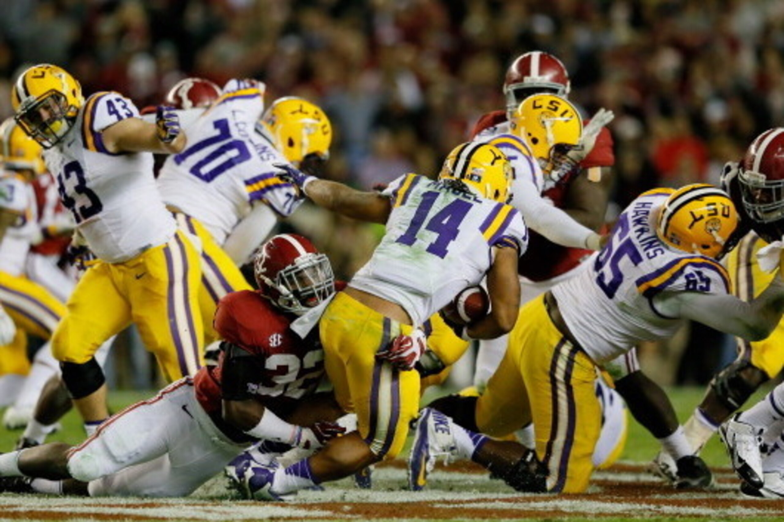 TUSCALOOSA, AL - NOVEMBER 09:  C.J. Mosley #32 of the Alabama Crimson Tide tackles Terrence Magee #14 of the LSU Tigers during the first half of the game at Bryant-Denny Stadium on November 9, 2013 in Tuscaloosa, Alabama.  (Photo by Kevin C. Cox/Getty Ima