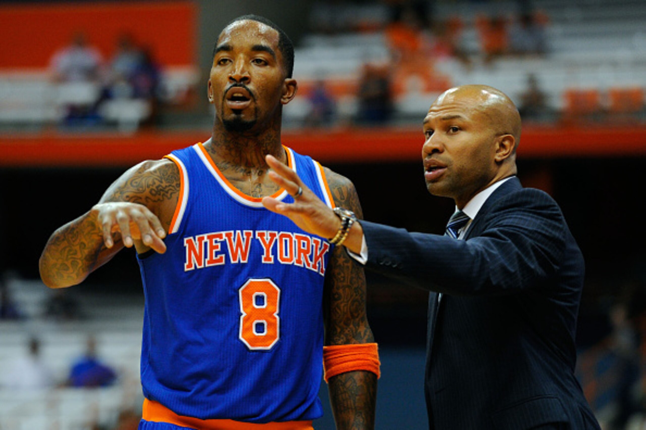 SYRACUSE, NY - OCTOBER 14:  J.R. Smith #8 and head coach Derek Fisher of the New York Knicks talk during a preseason game at the Carrier Dome on October 14, 2014 in Syracuse, New York.  The Knicks defeated the 76ers 84-77.  NOTE TO USER: User expressly ac