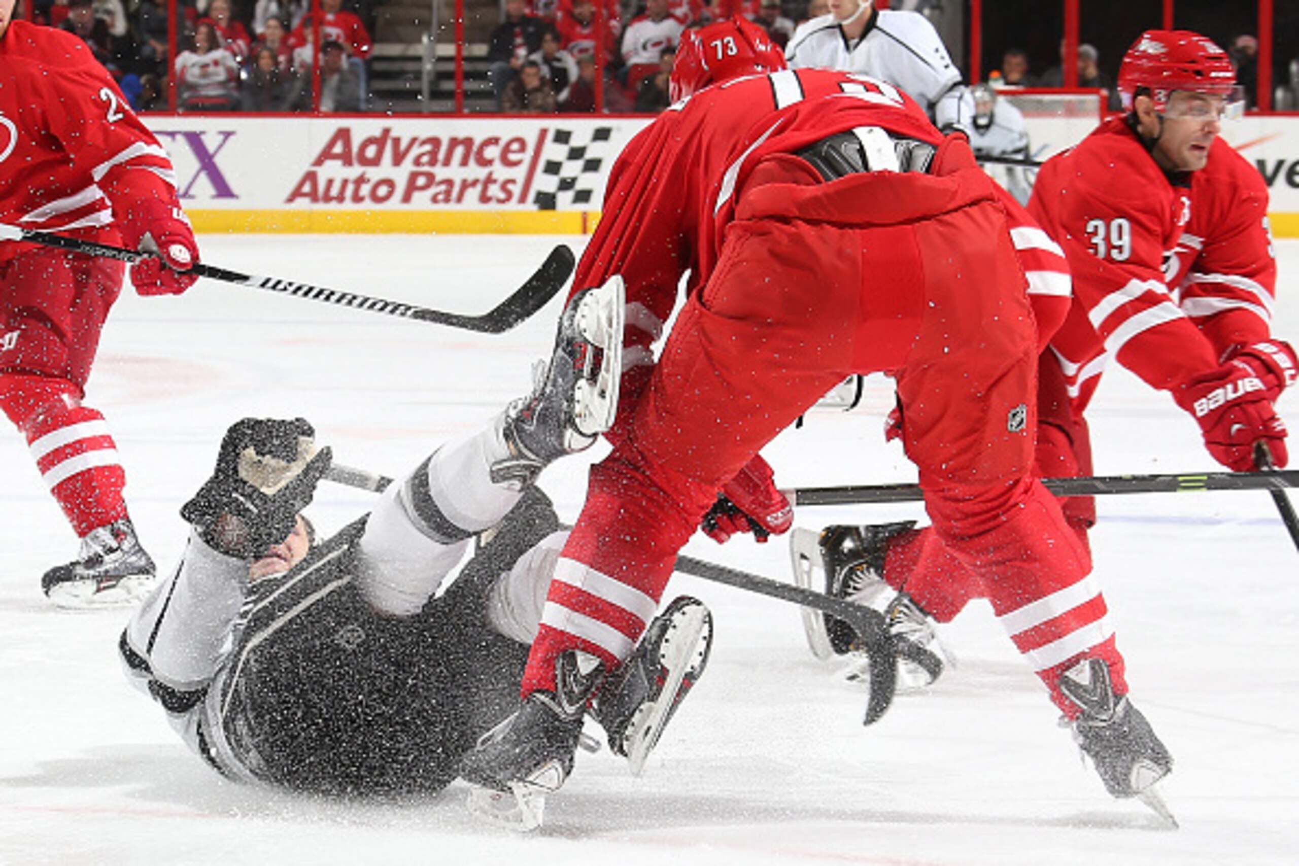 RALEIGH, NC - NOVEMBER 02: Brett Bellemore #73  of the Carolina Hurricanes collides with a member of the Los Angeles Kings during their NHL game at PNC Arena on November 2, 2014 in Raleigh, North Carolina.  (Photo by Gregg Forwerck/NHLI via Getty Images)