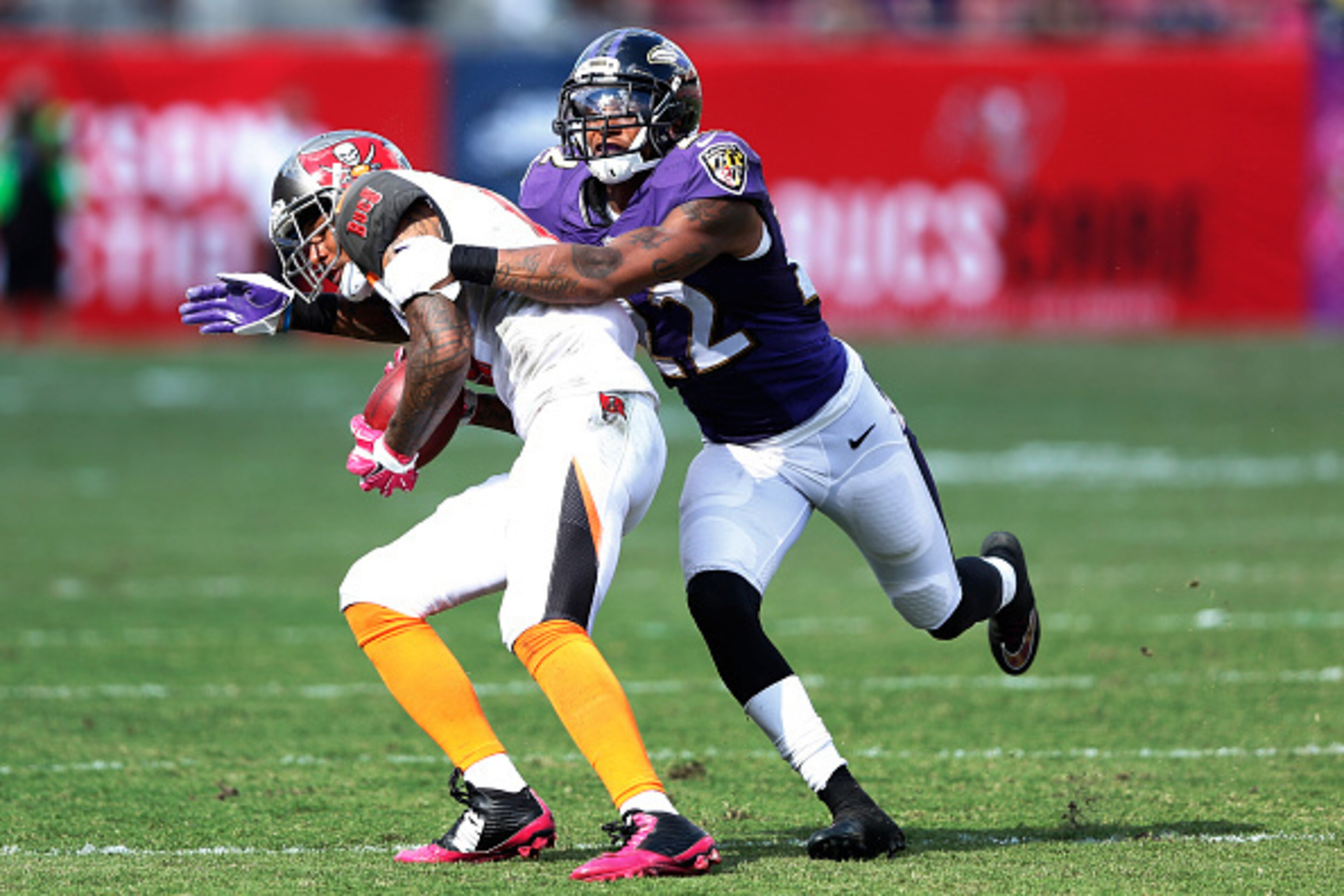 TAMPA, FL - OCTOBER 12: Jimmy Smith #22 of the Baltimore Ravens tackles Louis Murphy #18 of the Tampa Bay Buccaneers during the game at Raymond James Stadium on October 12, 2014 in Tampa, Florida. The Ravens defeated the Buccaneers 48-17. (Photo by Joe Ro