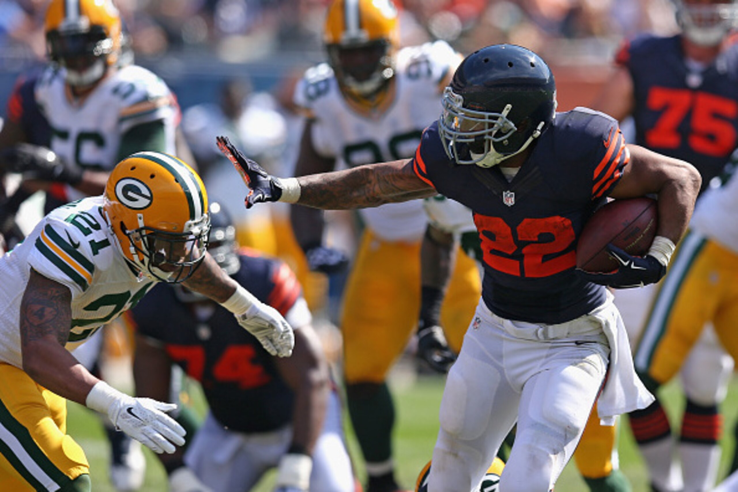 CHICAGO, IL - SEPTEMBER 28:  Matt Forte #22 of the Chicago Bears tries turnover avoid a tackle by  Ha Ha Clinton-Dix #21 of the Green Bay Packers during the first quarter at Soldier Field on September 28, 2014 in Chicago, Illinois. (Photo by Jonathan Dani