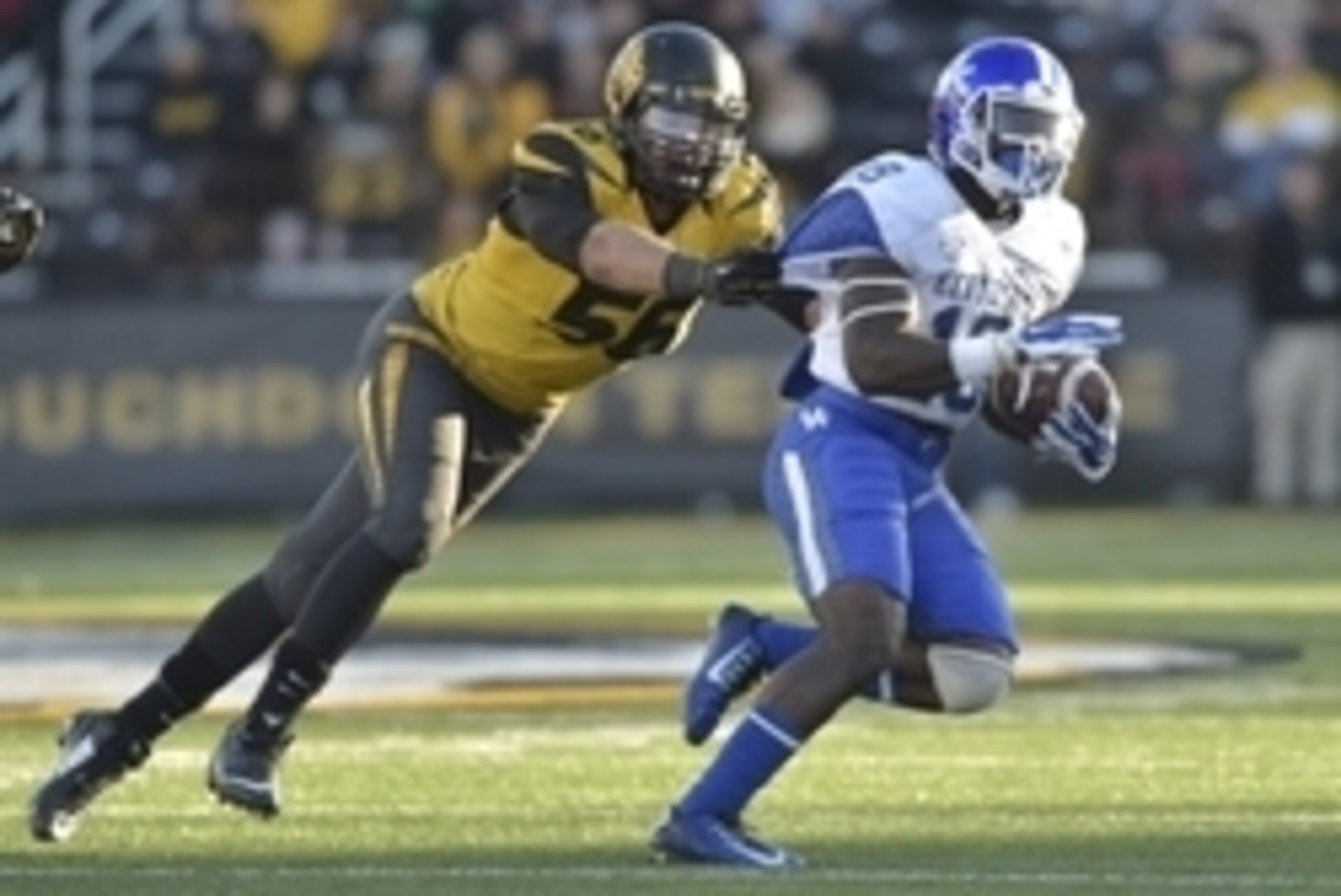 Nov 1, 2014; Columbia, MO, USA; Kentucky Wildcats running back Stanley Williams (18) is tackled by Missouri Tigers defensive lineman Shane Ray (56) during the second half at Faurot Field. Missouri won 20-10. Mandatory Credit: Denny Medley-USA TODAY Sports
