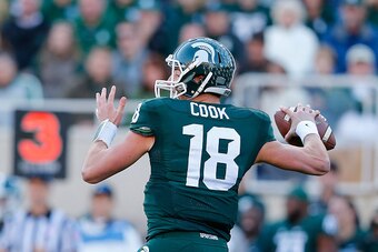 EAST LANSING, MI - OCTOBER 25: Quarterback Connor Cook #18 of the Michigan State Spartans drops back to pass during the third quarter of the game against the Michigan Wolverines at Spartan Stadium on October 25 , 2014 in East Lansing, Michigan. The Sparta