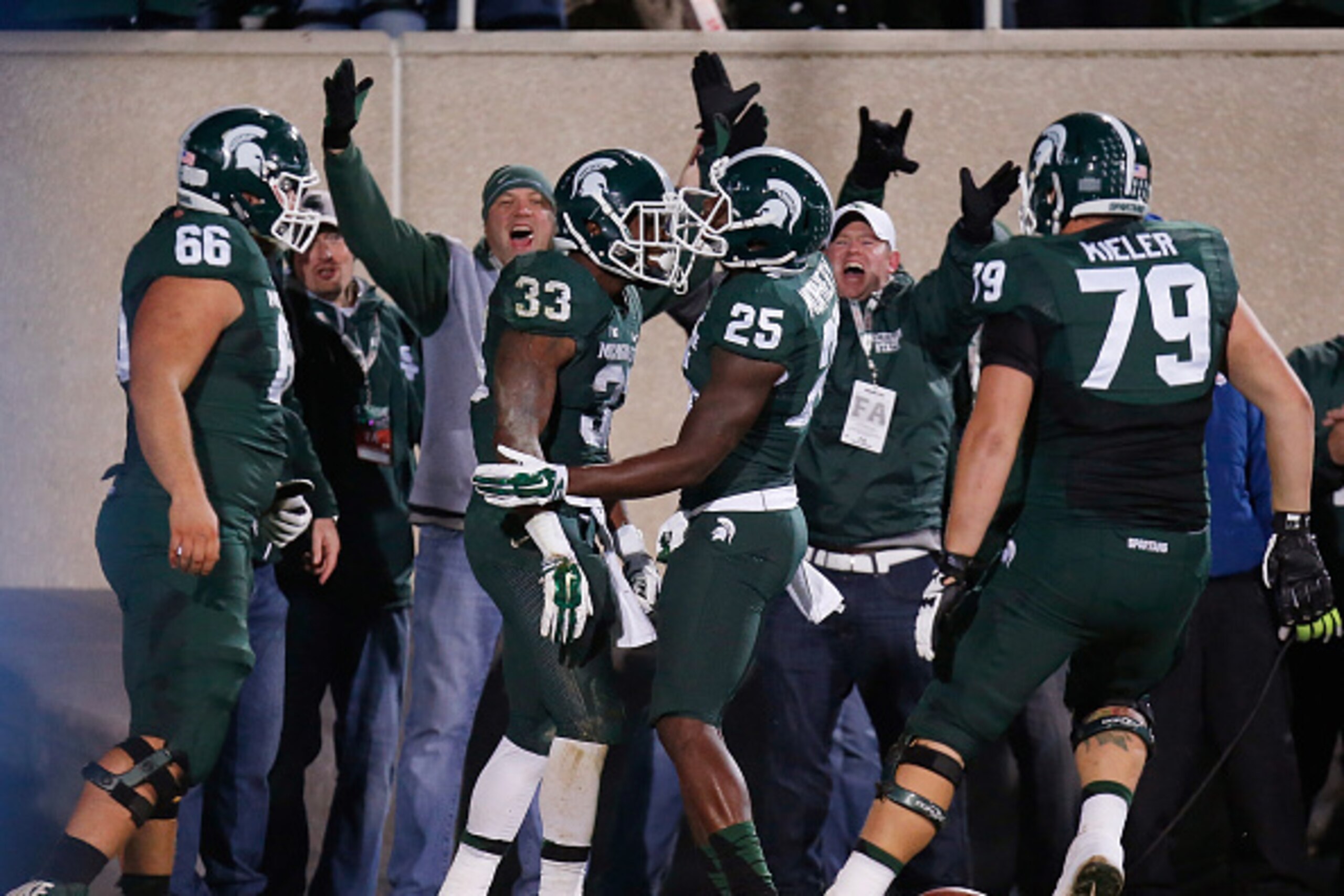 EAST LANSING, MI - OCTOBER 04: Jeremy Langford #33 of the Michigan State Spartans celebrators a first-quarter touchdown with Keith Mumphery #25, Kodi Kieler #79 and Jack Allen #66 against the Nebraska Cornhuskers at Spartan Stadium on October 4, 2014 in E