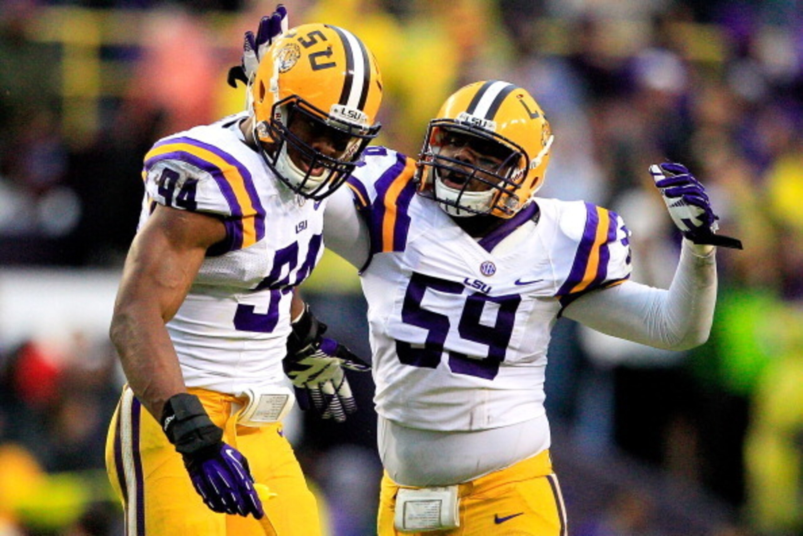BATON ROUGE, LA - NOVEMBER 23:  Defensive end Danielle Hunter #94 of the LSU Tigers celebrates with his teammate defensive end Jermauria Rasco #59 after sacking quarterback  Johnny Manziel #2 of the Texas A&M Aggies at Tiger Stadium on November 23, 2013 i