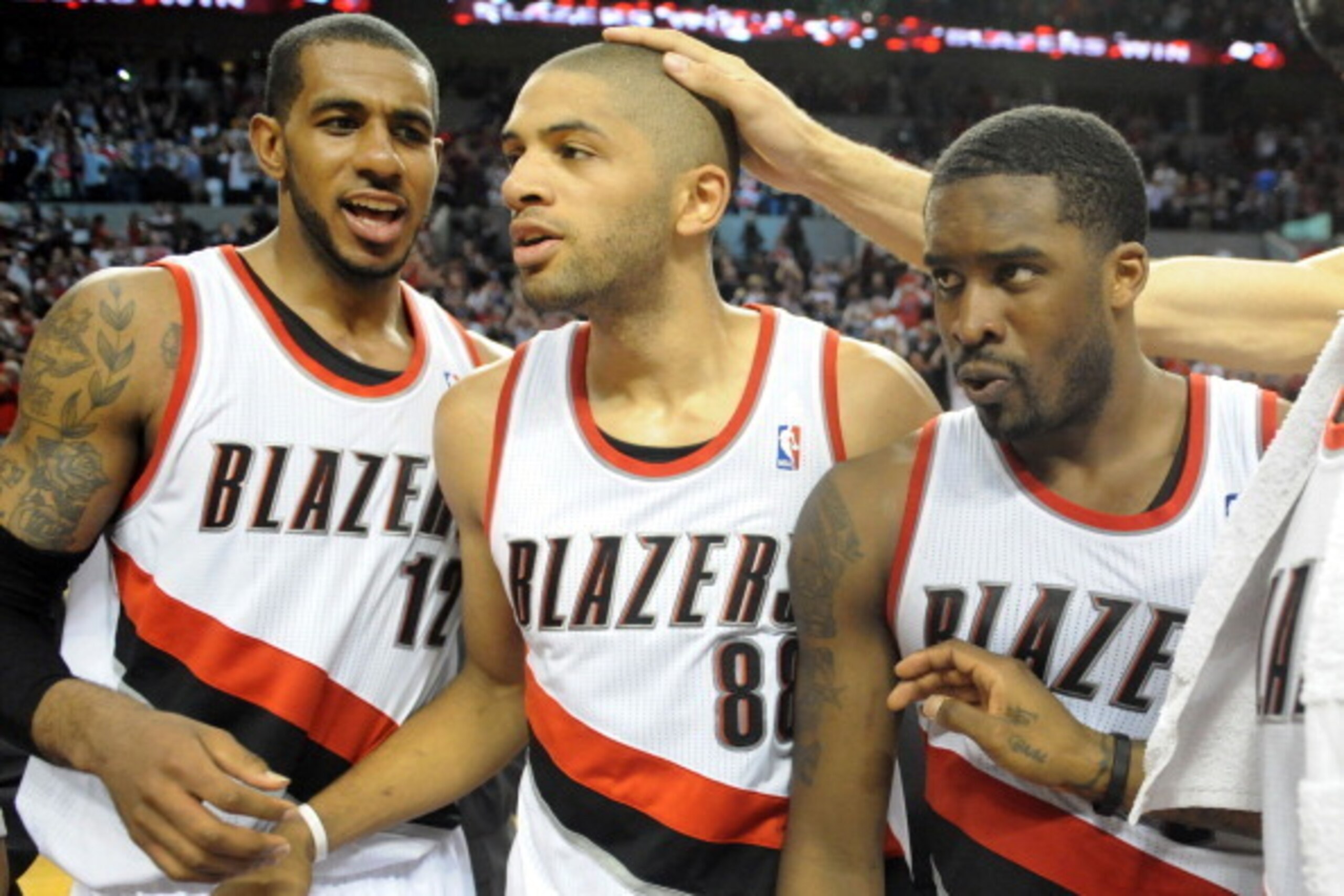 PORTLAND, OR - APRIL  27: LaMarcus Aldridge #12, Nicolas Batum #88 and Wesley Matthews #2 of the Portland Trail Blazers celebrate after Game Four of the Western Conference Quarterfinals during the 2014 NBA Playoffs at the Moda Center on April 27, 2014 in 