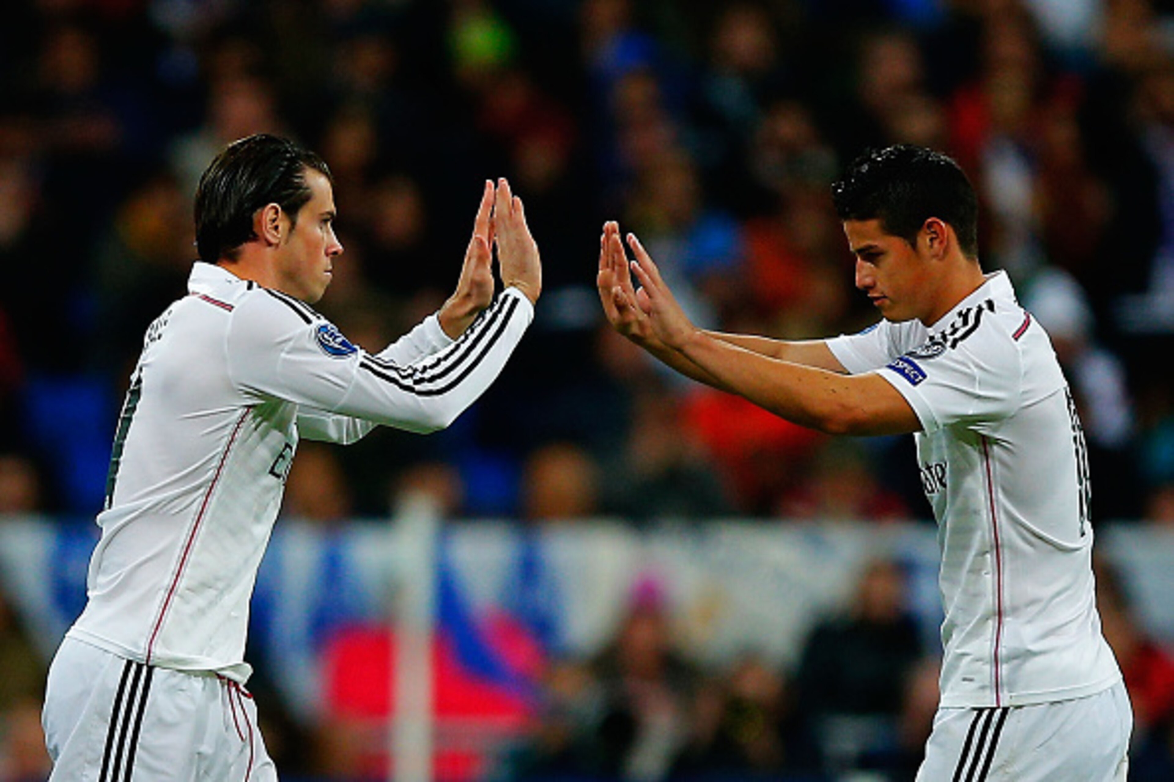 MADRID, SPAIN - NOVEMBER 04: Gareth Bale (L) of Real Madrid CF replaces team mate James Rodriguez (R) during the UEFA Champions League Group B match between Real Madrid CF and Liverpool FC at Estadio Santiago Bernabeu on November 4, 2014 in Madrid, Spain.