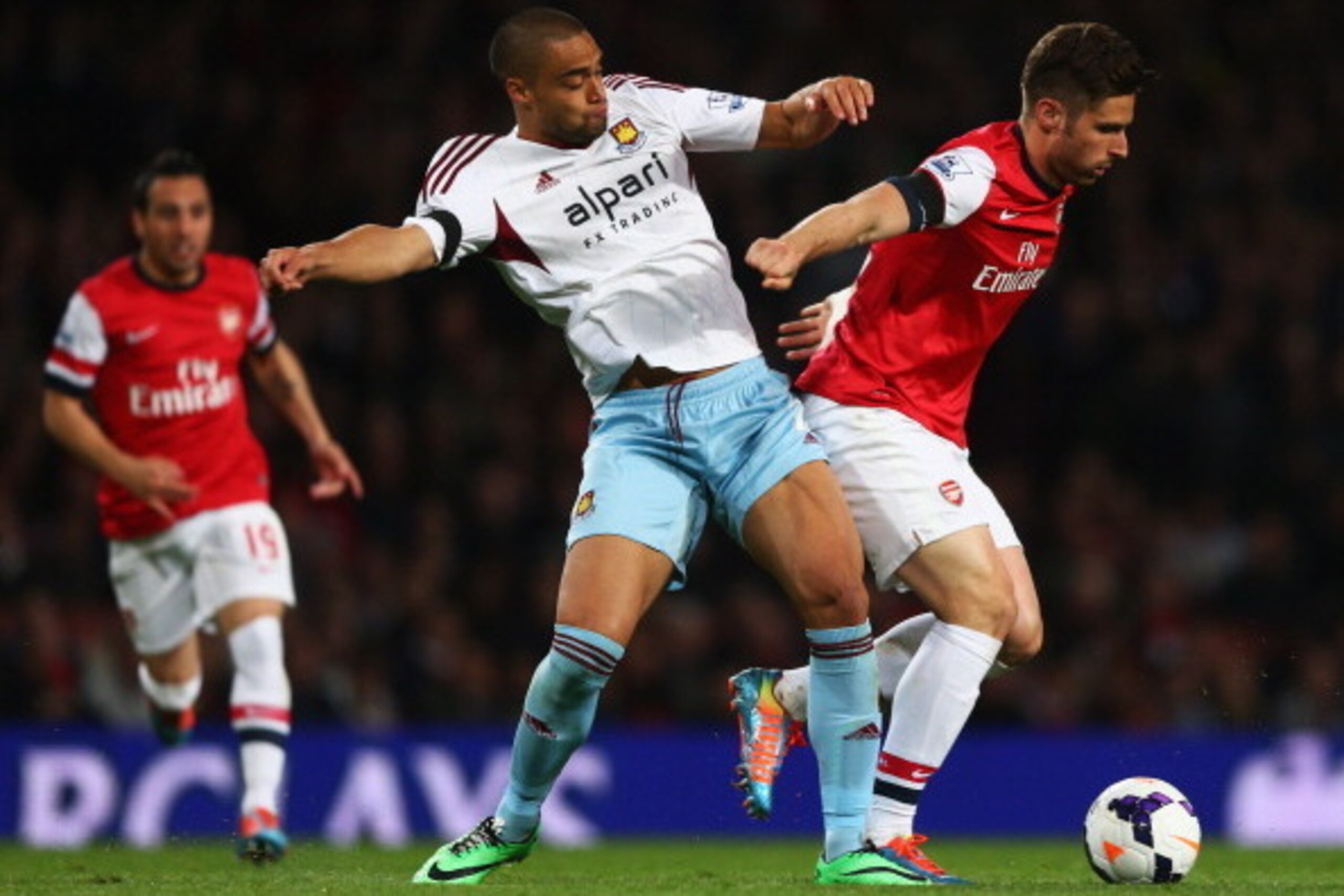 LONDON, ENGLAND - APRIL 15:  Olivier Giroud of Arsenal holds off Winston Reid of West Ham United during the Barclays Premier League match between Arsenal and West Ham United at Emirates Stadium on April 15, 2014 in London, England.  (Photo by Paul Gilham/
