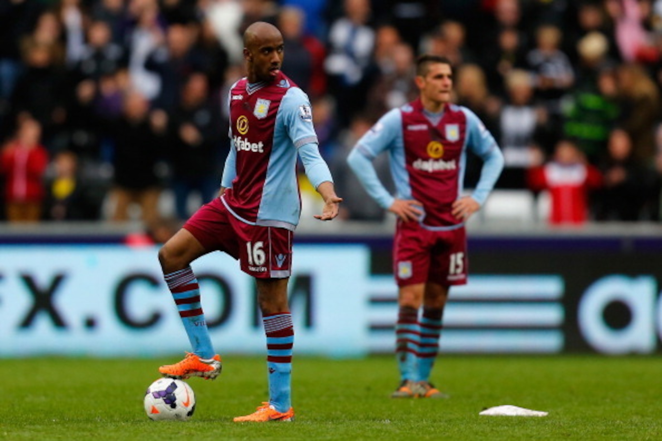 SWANSEA, WALES - APRIL 26:  A dejected Fabian Delph of Aston Villa looks on after Wilfried Bony of Swansea City scored their fourth goal during the Barclays Premier League match between Swansea City and Aston Villa at Liberty Stadium on April 26, 2014 in 
