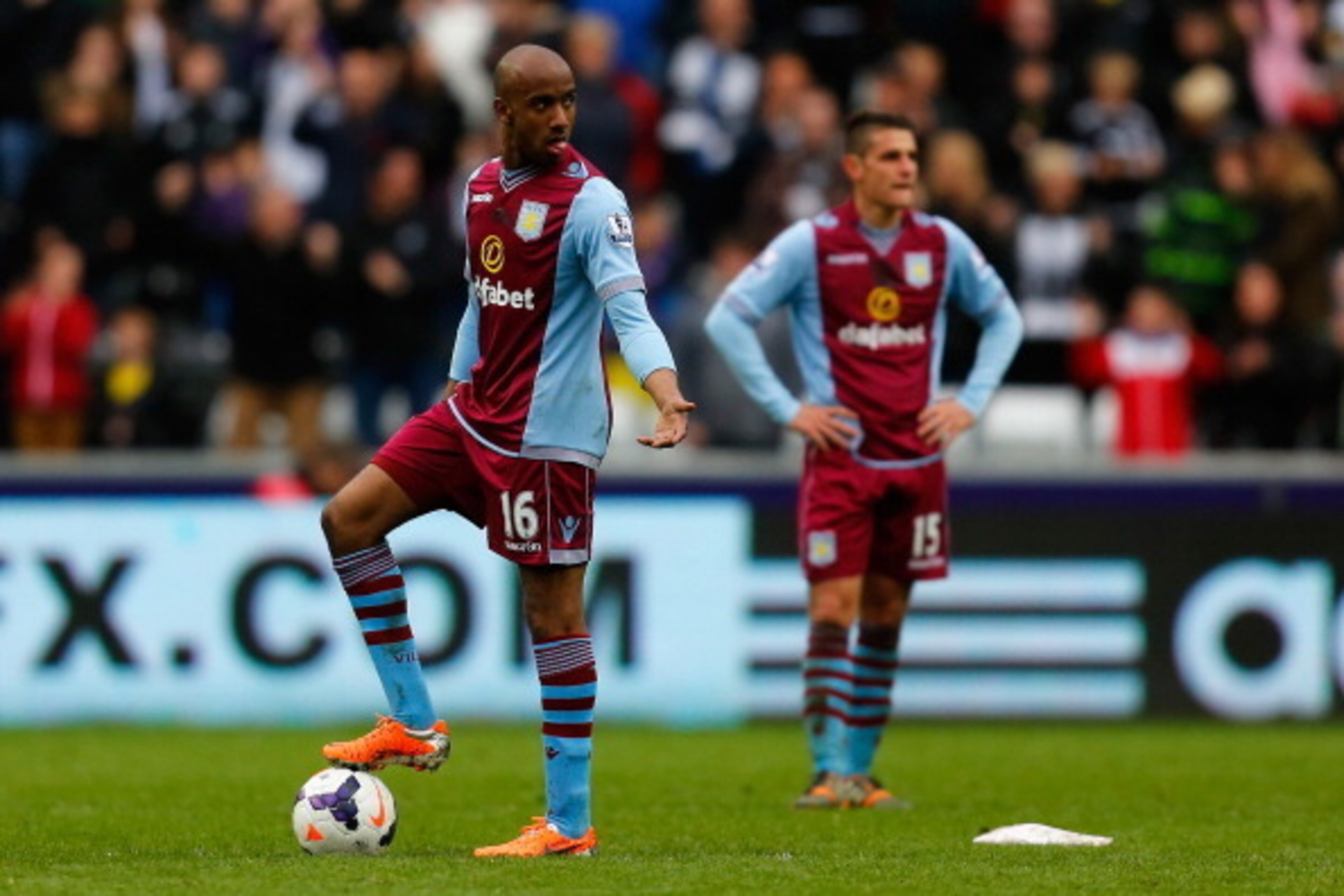 SWANSEA, WALES - APRIL 26:  A dejected Fabian Delph of Aston Villa looks on after Wilfried Bony of Swansea City scored their fourth goal during the Barclays Premier League match between Swansea City and Aston Villa at Liberty Stadium on April 26, 2014 in 