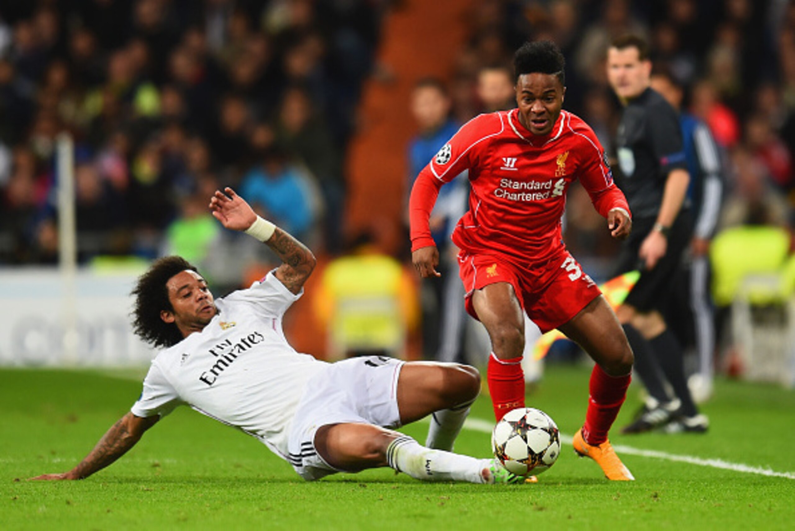 MADRID, SPAIN - NOVEMBER 04:  Marcelo of Real Madrid CF tackles Raheem Sterling of Liverpool during the UEFA Champions League Group B match between Real Madrid CF and Liverpool FC at Estadio Santiago Bernabeu on November 4, 2014 in Madrid, Spain.  (Photo 