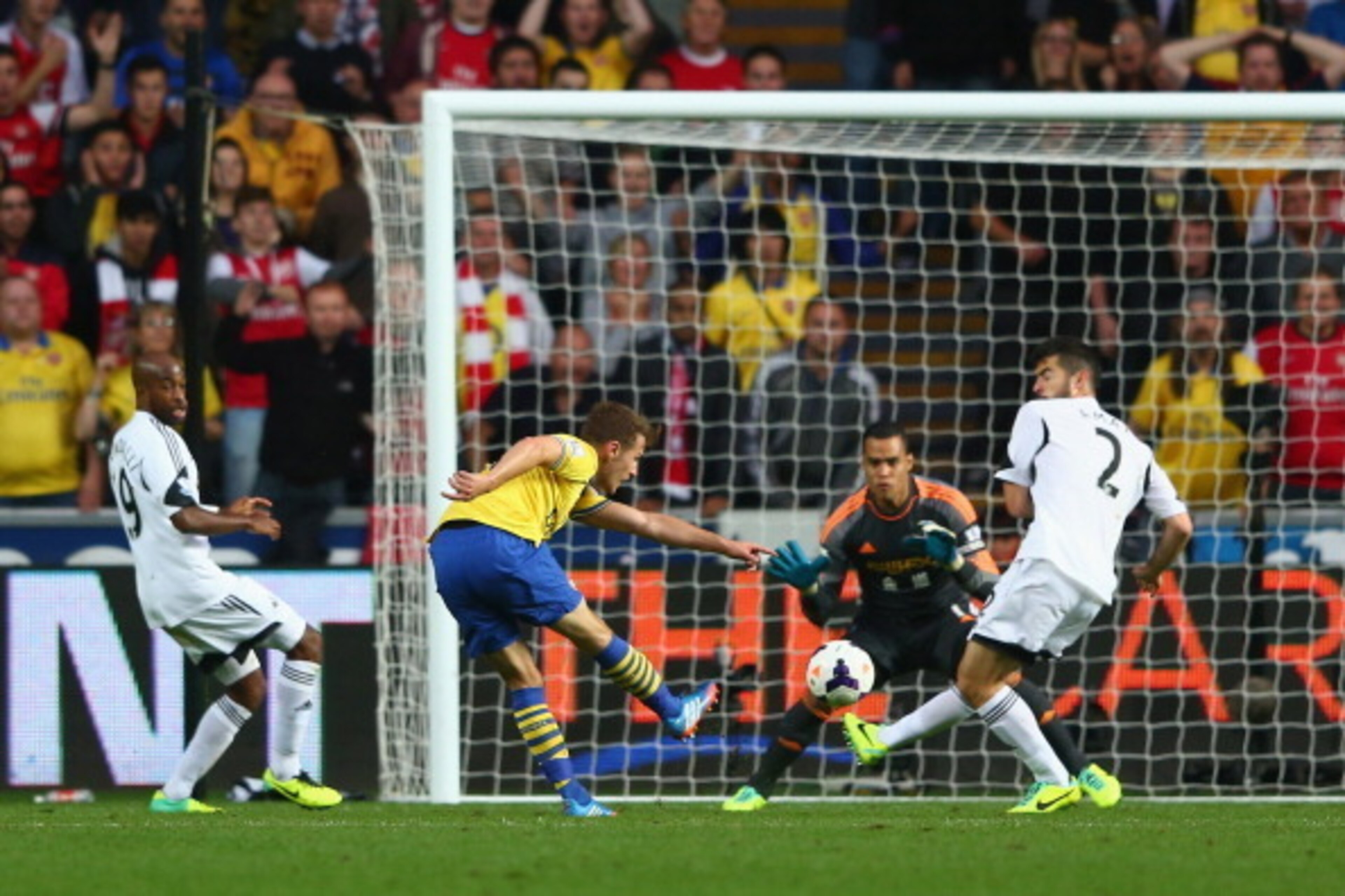 SWANSEA, WALES - SEPTEMBER 28:  Aaron Ramsey (2L) of Arsenal scores his sides second goal during the Barclays Premier League match between Swansea City and Arsenal at the Liberty Stadium on September 28, 2013 in Swansea, Wales.  (Photo by Michael Steele/G