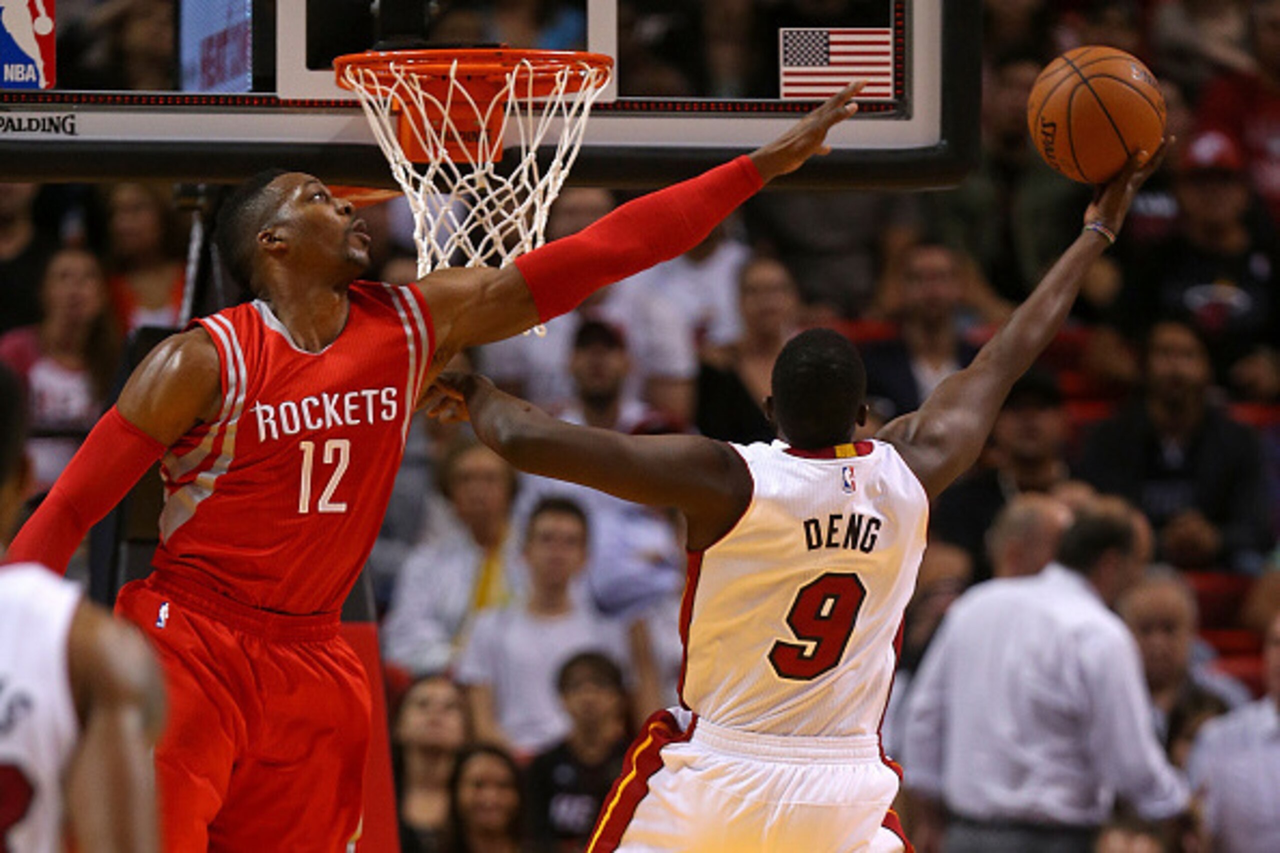 MIAMI, FL - NOVEMBER 04: Luol Deng #9 of the Miami Heat shoots over Dwight Howard #12 of the Houston Rockets during a game  at American Airlines Arena on November 4, 2014 in Miami, Florida. NOTE TO USER: User expressly acknowledges and agrees that, by dow