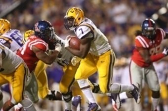 Oct 25, 2014; Baton Rouge, LA, USA; LSU Tigers running back Leonard Fournette (7) carries the ball against the Mississippi Rebels in the first half at Tiger Stadium. Mandatory Credit: Crystal LoGiudice-USA TODAY Sports