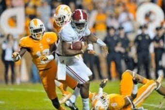 Oct 25, 2014; Knoxville, TN, USA; Alabama Crimson Tide quarterback Blake Sims (6) rushes for a touchdown against Tennessee Volunteers defensive back Todd Kelly Jr. (6) and defensive back Emmanuel Moseley (12) during the first half game at Neyland Stadium.