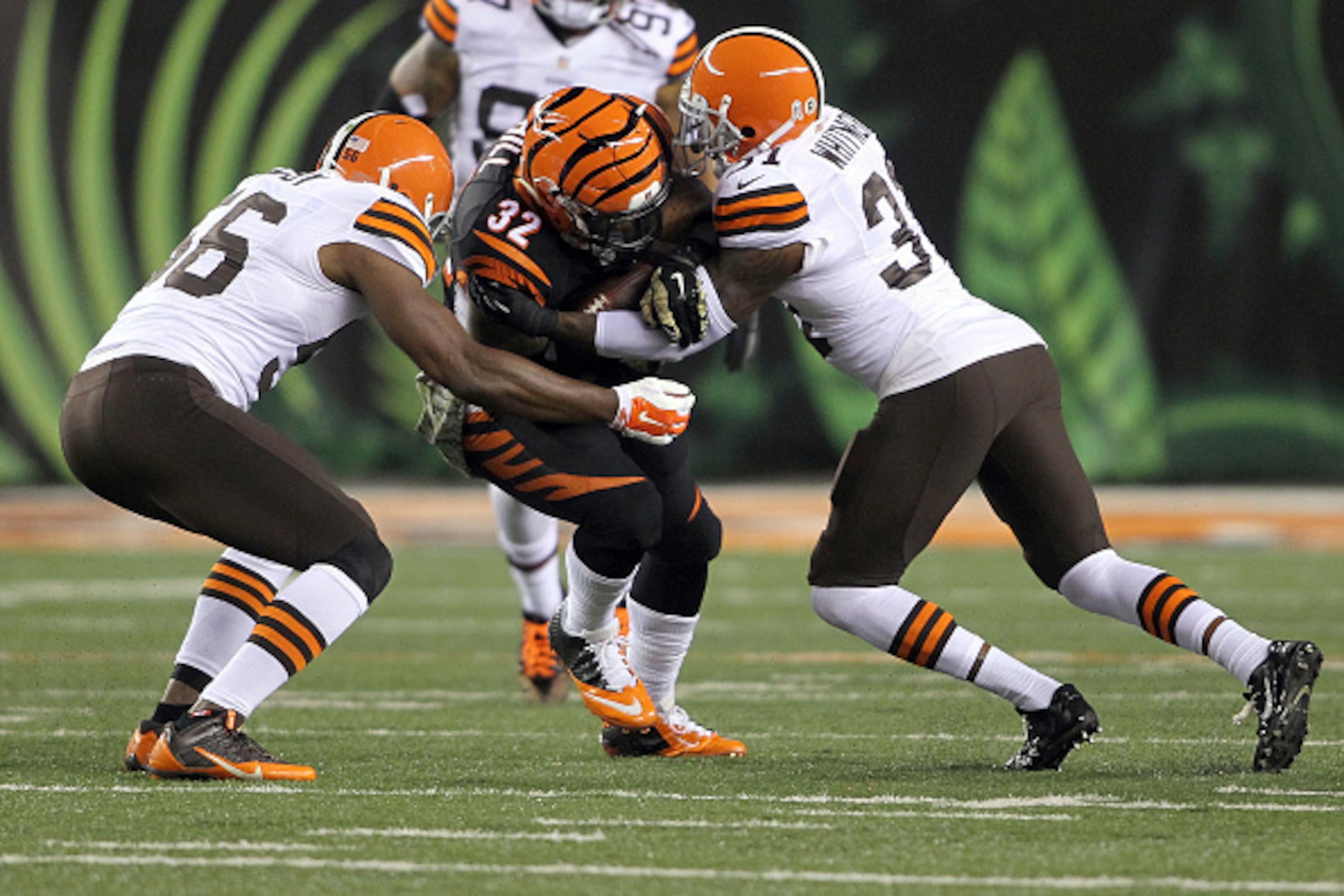 CINCINNATI, OH - NOVEMBER 6: Karlos Dansby #56 of the Cleveland Browns and Donte Whitner #31 of the Cleveland Browns combine to tackle Jeremy Hill #32 of the Cincinnati Bengals during the first quarter at Paul Brown Stadium on November 6, 2014 in Cincinn CINCINNATI, OH - NOVEMBER 6: Karlos Dansby #56 of the Cleveland Browns and Donte Whitner #31 of the Cleveland Browns combine to tackle Jeremy Hill #32 of the Cincinnati Bengals during the first quarter at Paul Brown Stadium on November 6, 2014 in Cincinn