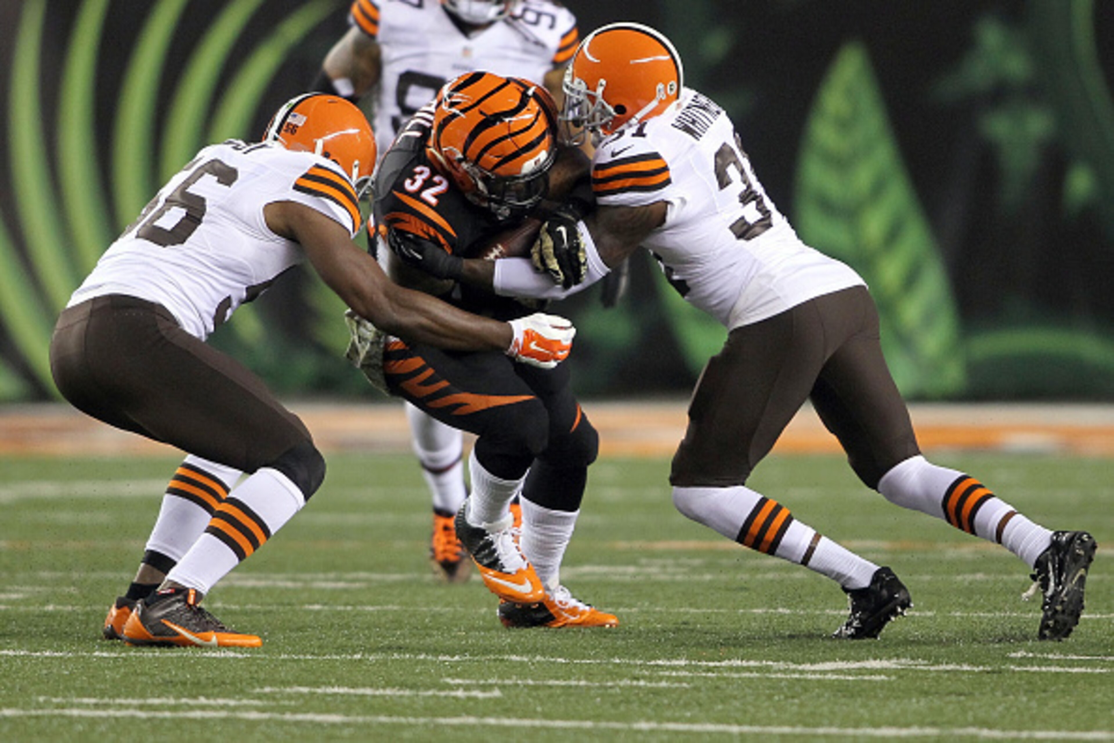 CINCINNATI, OH - NOVEMBER 6:  Karlos Dansby #56 of the Cleveland Browns and Donte Whitner #31 of the Cleveland Browns combine to tackle Jeremy Hill #32 of the Cincinnati Bengals during the first quarter at Paul Brown Stadium on November 6, 2014 in Cincinn