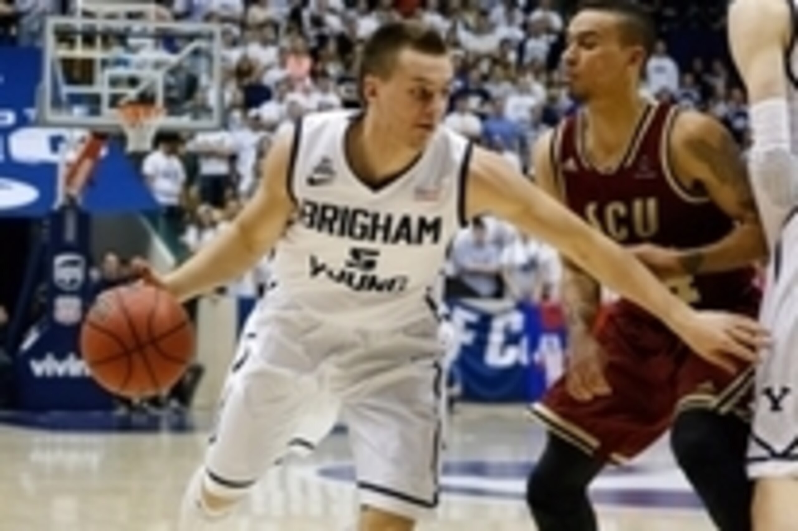 Feb 6, 2014; Provo, UT, USA; Brigham Young Cougars guard Kyle Collinsworth (5) uses a pick by Brigham Young Cougars forward Nate Austin (33) to get past Santa Clara Broncos guard Evan Roquemore (24) during the second half at Marriott Center.  Brigham Youn