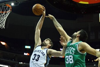 MEMPHIS, TN - NOVEMBER 04:  Marc Gasol #33 of the Memphis Grizzlies grabs a rebound over Victor Faverani #38 of the Boston Celtics during the NBA game at FedExForum on November 4, 2013 in Memphis, Tennessee.  NOTE TO USER: User expressly acknowledges and 
