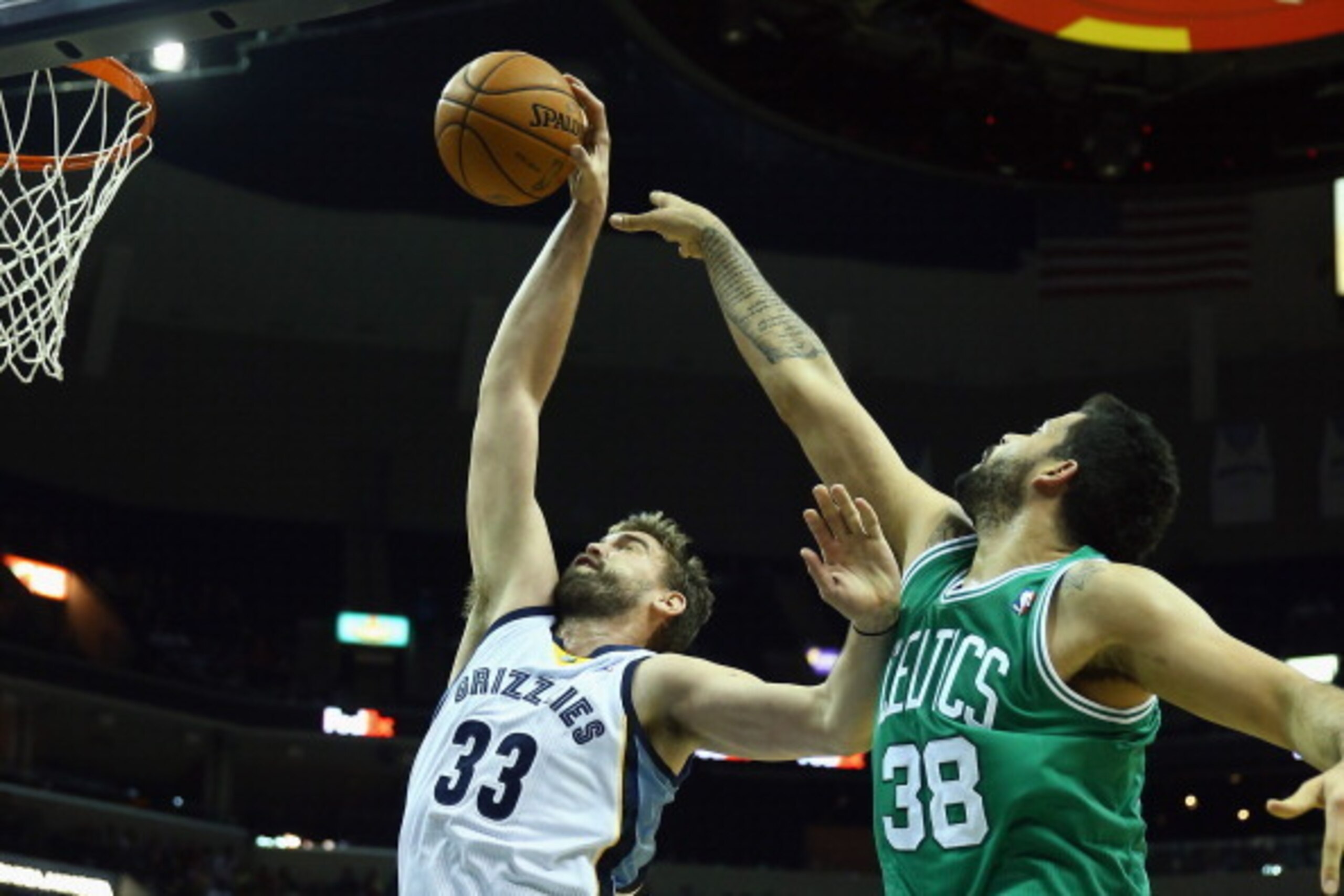 MEMPHIS, TN - NOVEMBER 04:  Marc Gasol #33 of the Memphis Grizzlies grabs a rebound over Victor Faverani #38 of the Boston Celtics during the NBA game at FedExForum on November 4, 2013 in Memphis, Tennessee.  NOTE TO USER: User expressly acknowledges and 