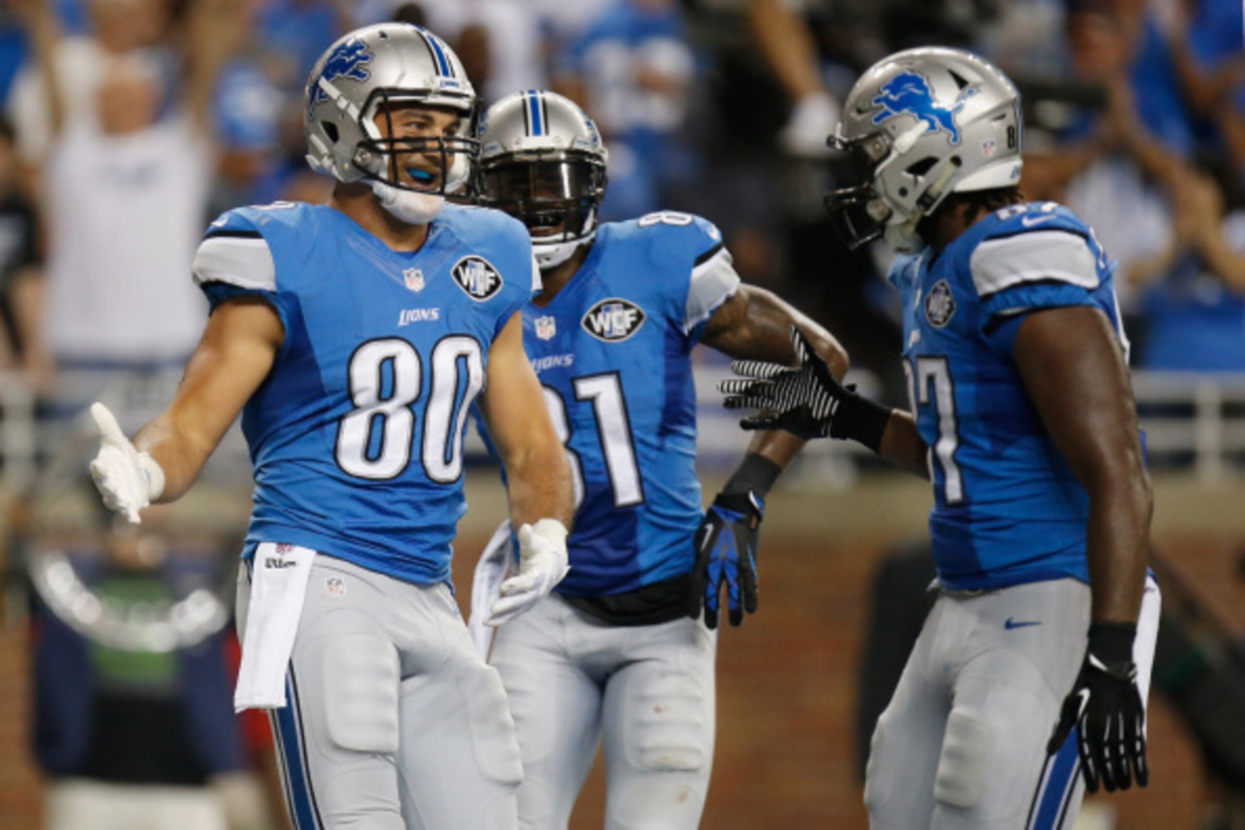 DETROIT, MI - SEPTEMBER 08: Joseph Fauria #80, Calvin Johnson #81and Brandon Pettigrew #87 of the Detroit Lions celebrate a two point conversion against the New York Giants at Ford Field on September 8, 2014 in Detroit, Michigan. (Photo by Gregory Shamus/