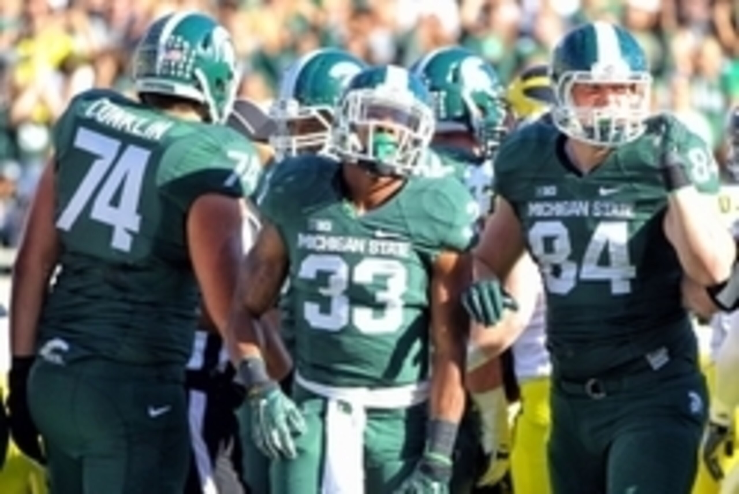 Oct 25, 2014; East Lansing, MI, USA; Michigan State Spartans running back Jeremy Langford (33) celebrates a touchdown with tight end Andrew Gleichert (84) and offensive lineman Dennis Finley (73) during the 2nd half of a game at Spartan Stadium.  MSU won 