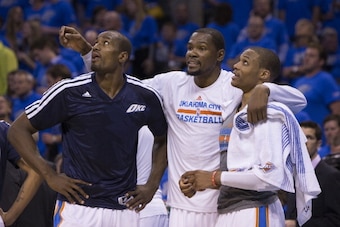 OKLAHOMA CITY, OK - APRIL 19:  Serge Ibaka #9, Kevin Durant #35 and Russell Westbrook #0 of the Oklahoma City Thunder talk during the Memphis Grizzlies in Game One of the Western Conference Quarterfinals of the NBA Playoffs at Chesapeake Energy Arena on A