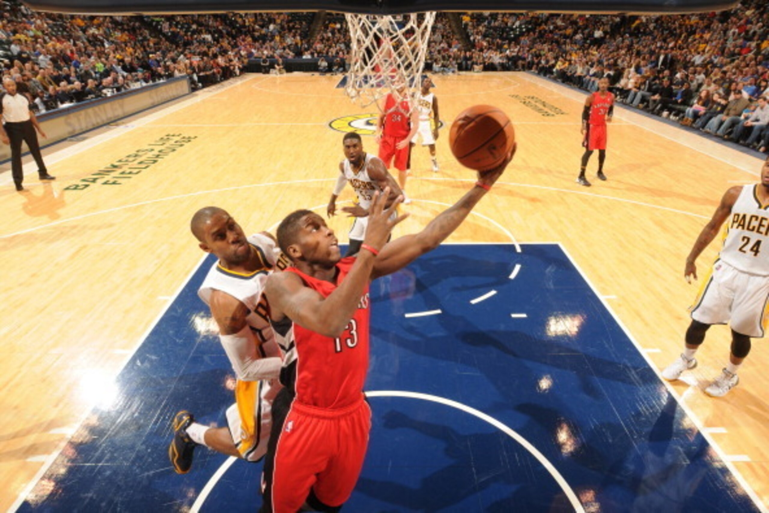 INDIANAPOLIS - NOVEMBER 8: Dwight Buycks #13 of the Toronto Raptors shoots against C.J. Watson #32 of the Indiana Pacers at Bankers Life Fieldhouse on November 8, 2013 in Indianapolis, Indiana.  NOTE TO USER: User expressly acknowledges and agrees that, b