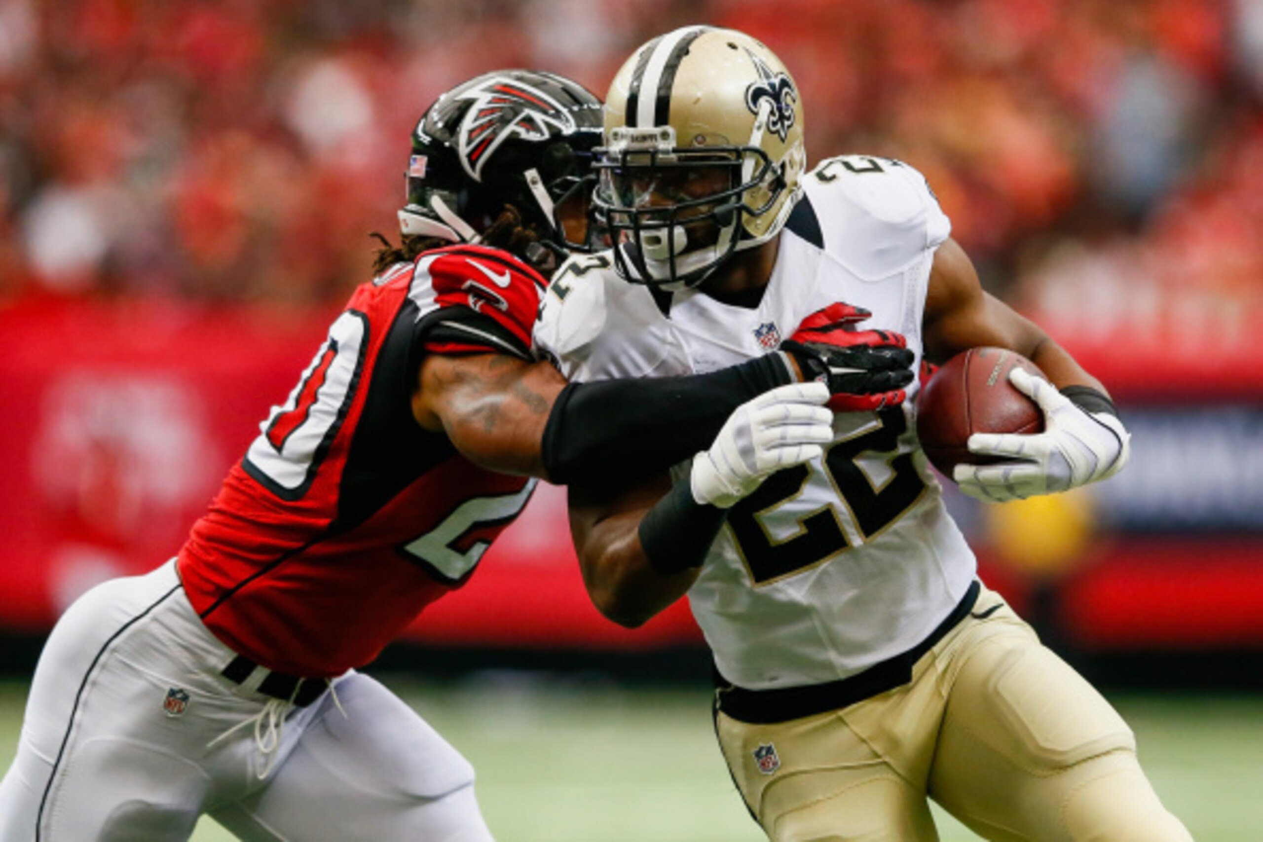 ATLANTA, GA - SEPTEMBER 07: Mark Ingram #22 of the New Orleans Saints is tackled on a run by Dwight Lowery #20 of the Atlanta Falcons in the first quarter at the Georgia Dome on September 7, 2014 in Atlanta, Georgia.  (Photo by Kevin C. Cox/Getty Images)