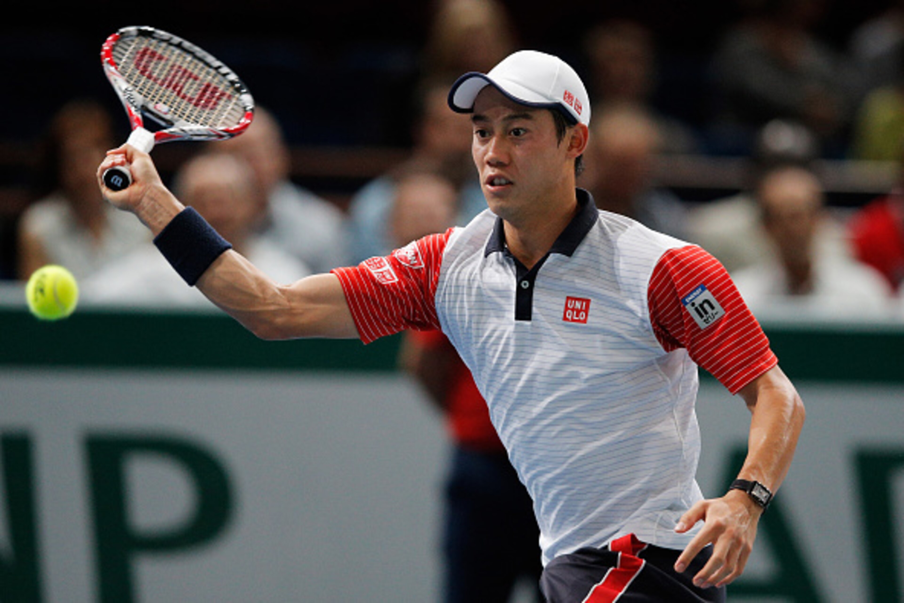 PARIS, FRANCE - NOVEMBER 01:  Kei Nishikori of Japan in action against Novak Djokovic of Serbia in their semi final match during day 6 of the BNP Paribas Masters held at the at Palais Omnisports de Bercy on November 1, 2014 in Paris, France.  (Photo by De