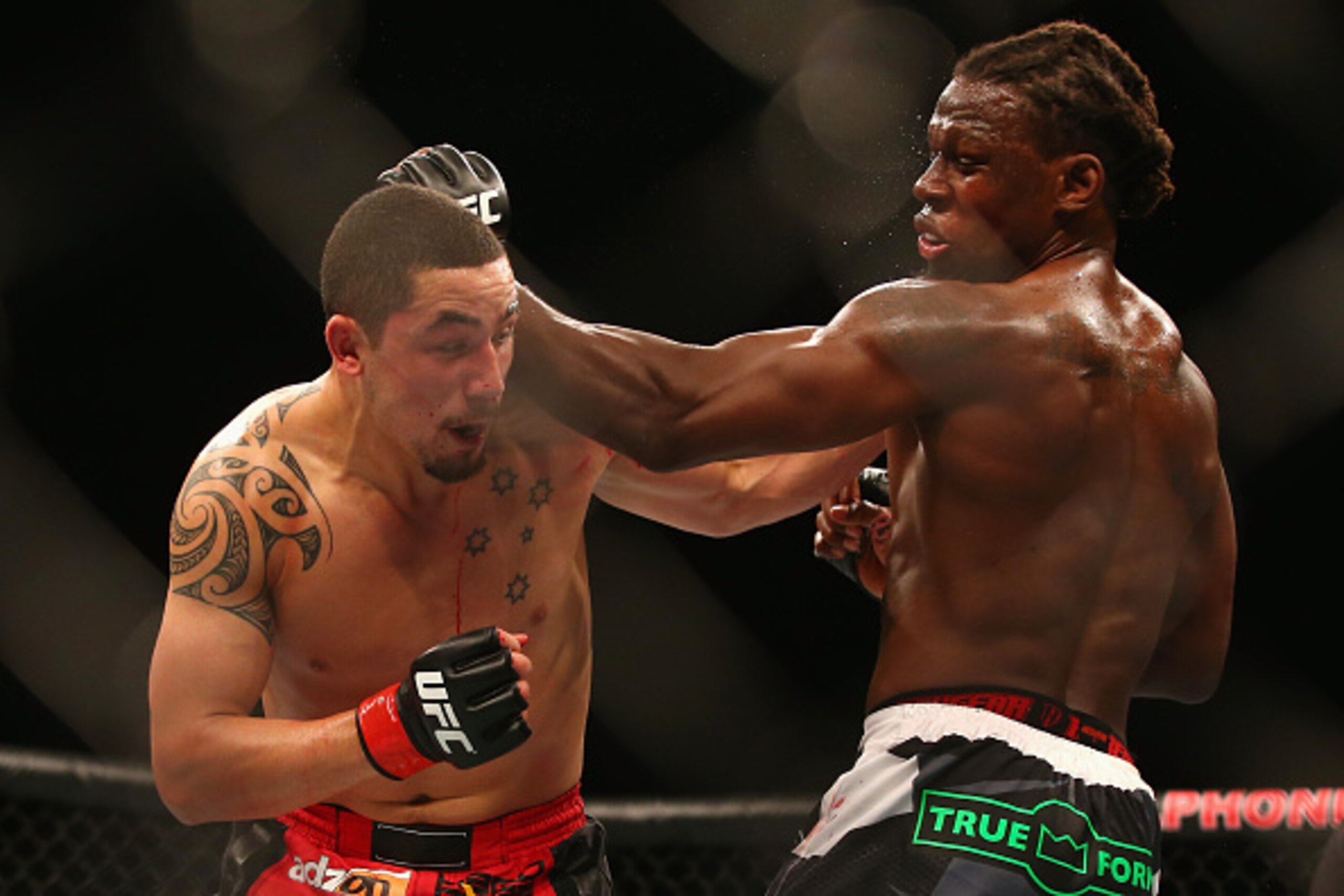 SYDNEY, AUSTRALIA - NOVEMBER 08:  Robert Whittaker of Australia connects with a left  to the face of Clint Hester in their middleweight fight during the UFC Fight Night 55 event at Allphones Arena on November 8, 2014 in Sydney, Australia.  (Photo by Mark 