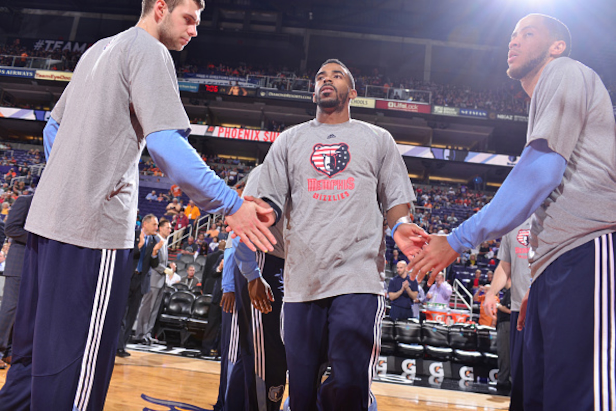 PHOENIX, AZ -  NOVEMBER 5: Mike Conley #11 of the Memphis Grizzlies high fives teammates during the introduction before the game on November 5, 2014 at US Airways Center in Phoenix, Arizona. NOTE TO USER: User expressly acknowledges and agrees that, by do