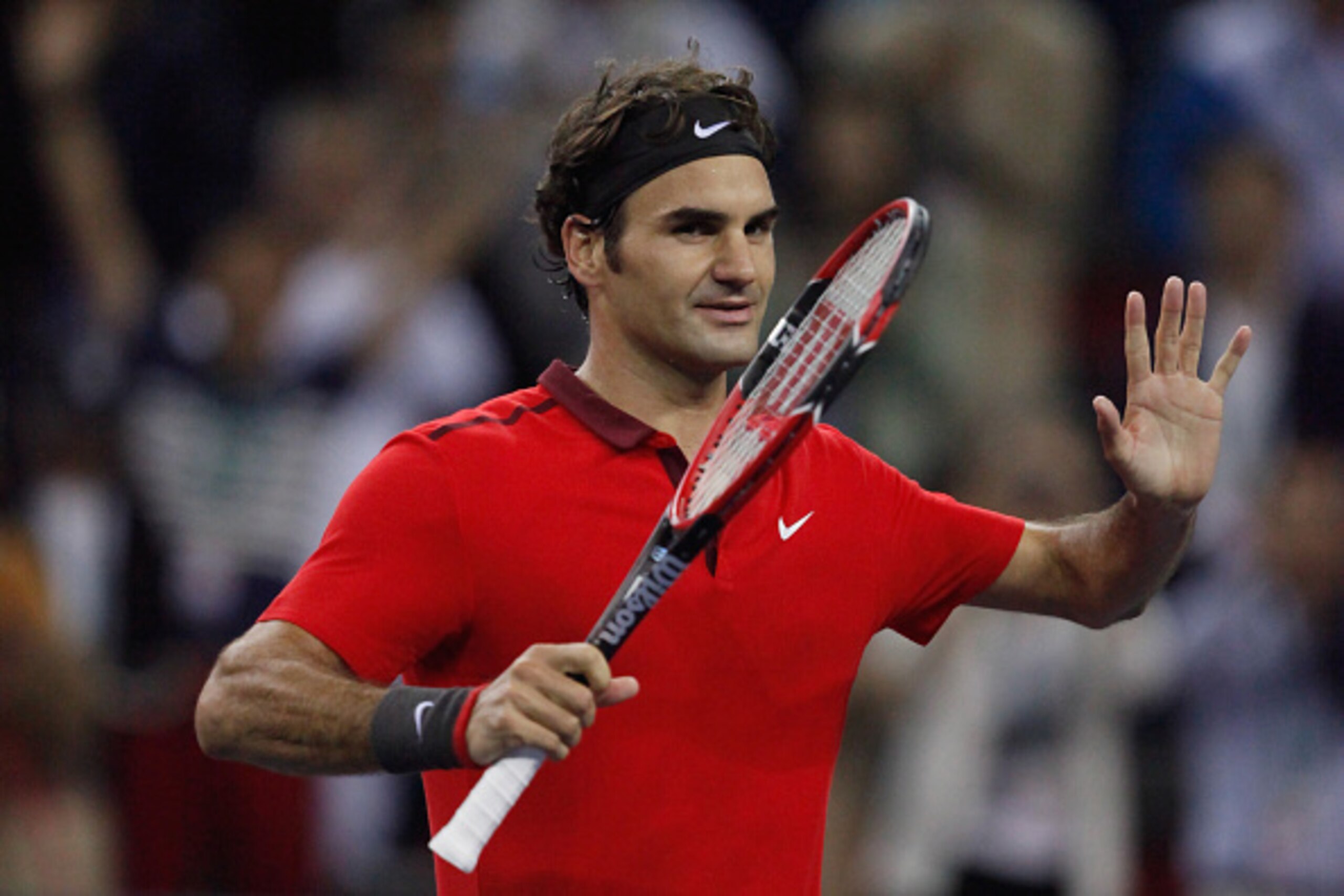 SHANGHAI, CHINA - OCTOBER 11: Roger Federer of Switzerland waves to spectators after beating Novak Djokovic of Serbia during day 7 of the Shanghai Rolex Masters at Zi Zhong stadium on October 11, 2014 in Shanghai, China. (Photo by Kevin Lee/Getty Images)