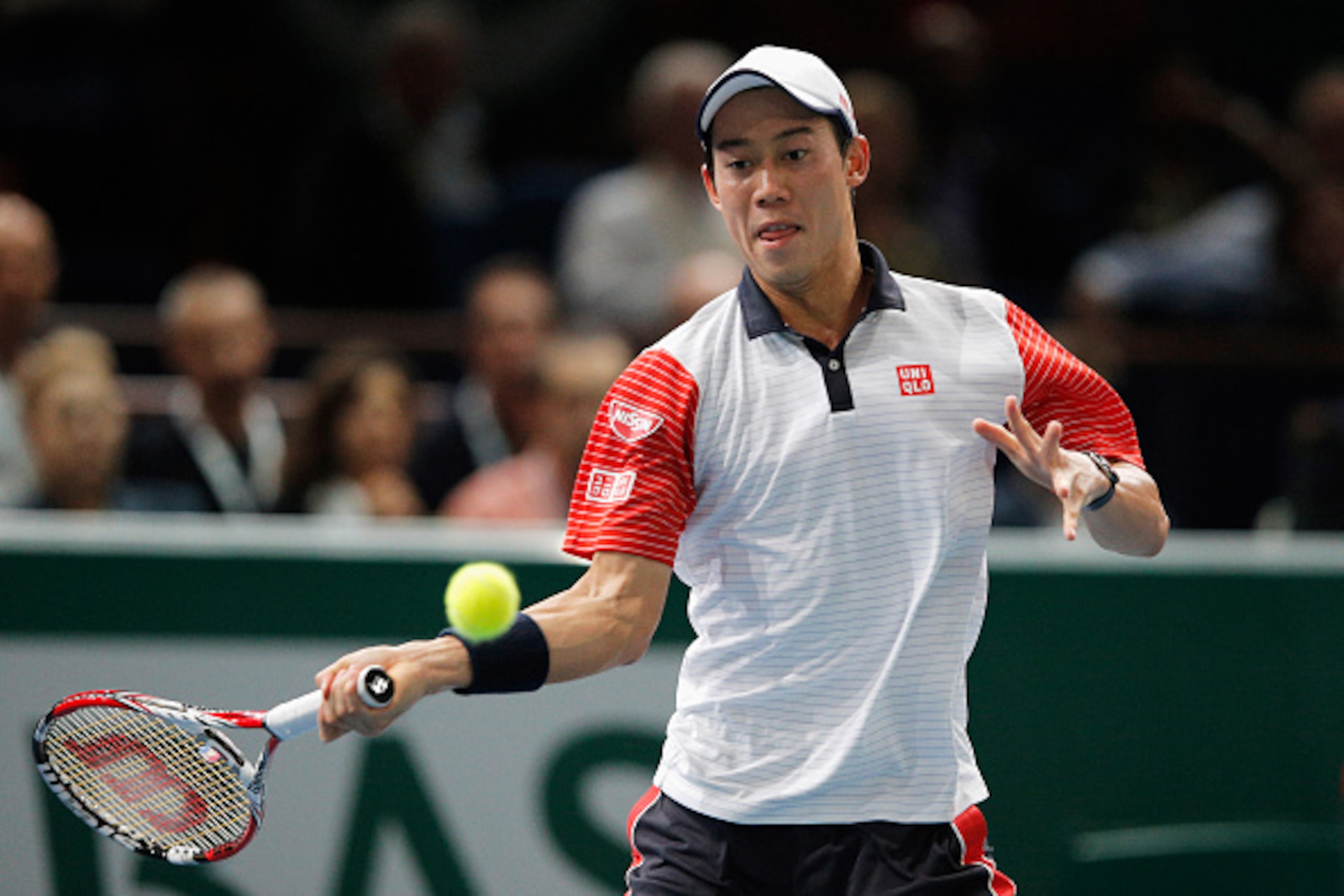 PARIS, FRANCE - NOVEMBER 01:  Kei Nishikori of Japan in action against Novak Djokovic of Serbia in their semi final match during day 6 of the BNP Paribas Masters held at the at Palais Omnisports de Bercy on November 1, 2014 in Paris, France.  (Photo by De